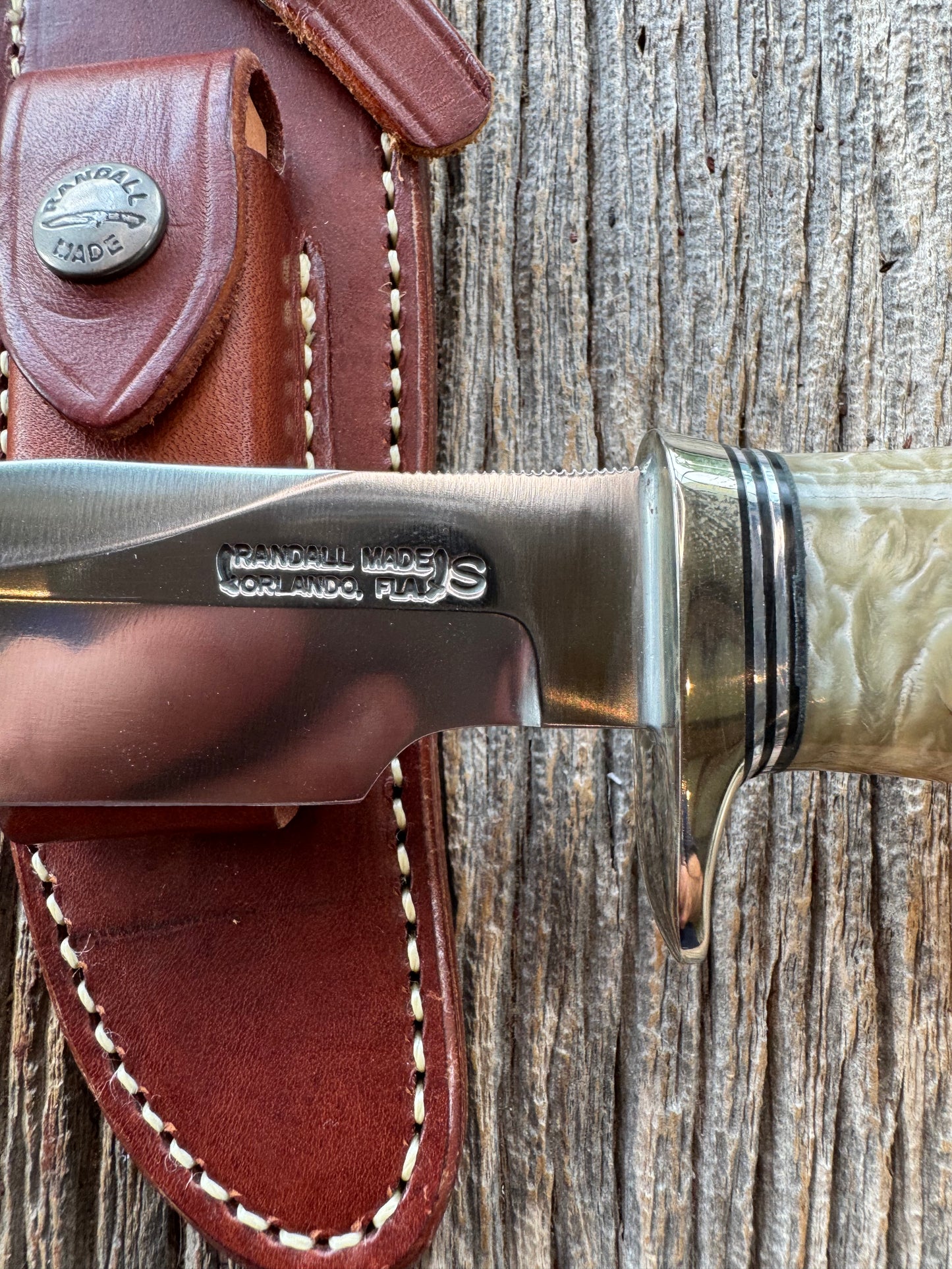 Randall Model 12-6 in Musk Ox. Natural raw end. Nickel Silver Single Hilt and Black and Aluminum spacers, stainless steel blade.