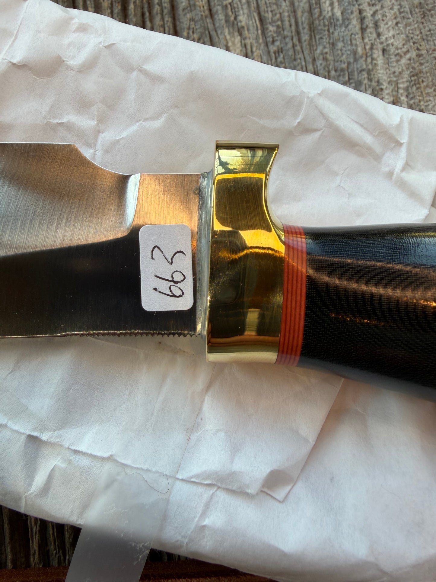 New in Paper Randall Chef’s Knife. Black Micarta in Brass with red spacers. Natural end, stainless steel blade and a lanyard.