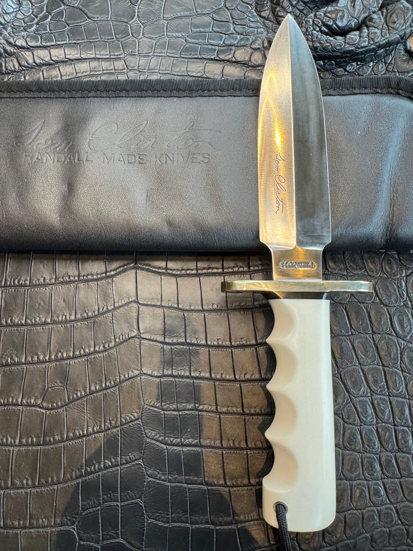 Randall Tom Clinton Dealer Special. Clinton Blade etched Commemorative 1/100 in a nice piece of finger grooved Ivorite. Very cool Black Crocodile skull Gutcher sheath. Nickel Silver Hilt. Included in black facsimile Tom Clinton case.