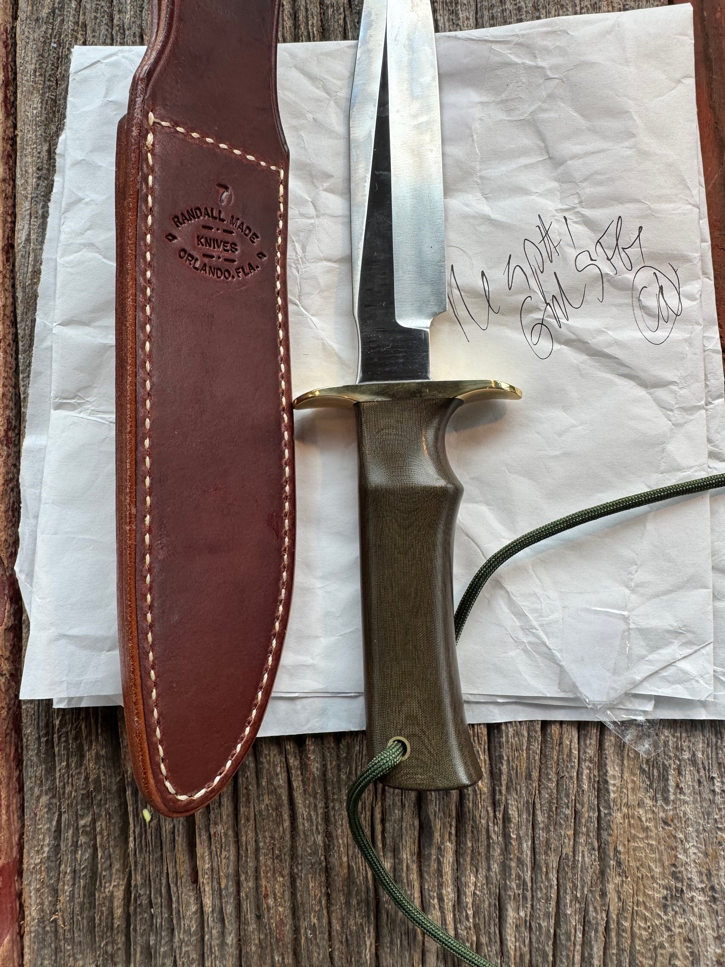 New in Paper Randall Model 16 SP#1 Special fighter with a Green Micarta handle. SS blade, Brass hilt. Lanyard. Brown leather sheath.