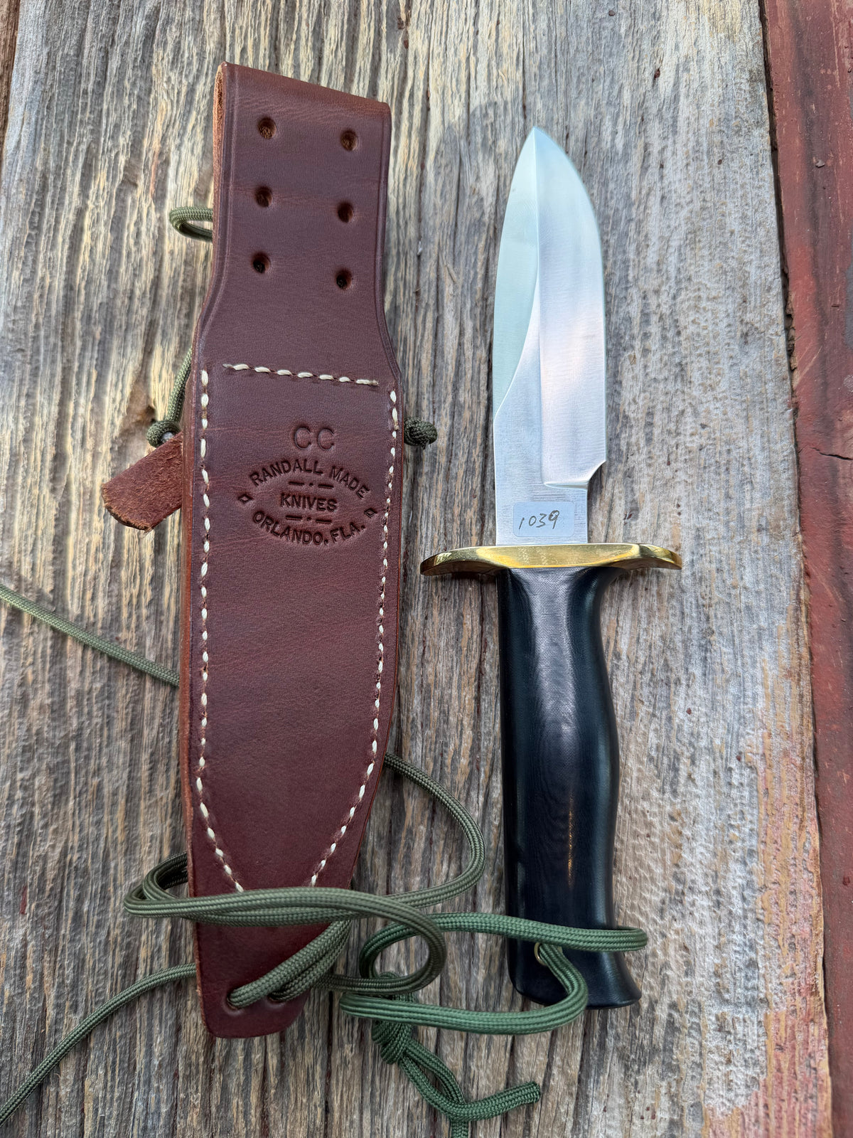 Nice Randall Model Combat Companion in Black Micarta. SS blade, brass hilt. Lanyard and paracord, Brown leather sheath.