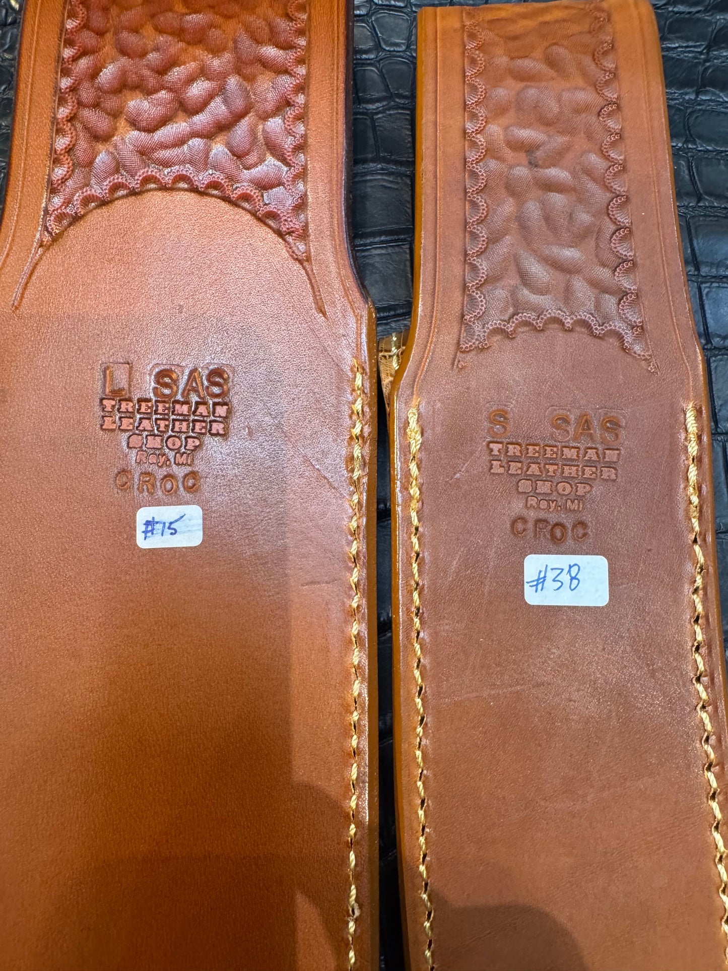 A pair of Randall Model 12-11 Large Sasquatch (Tail) and Randall Model 12-8 Small Sasquatch (Skull) Sheaths in Exotic Tan Hornback Crocodile by Treeman.