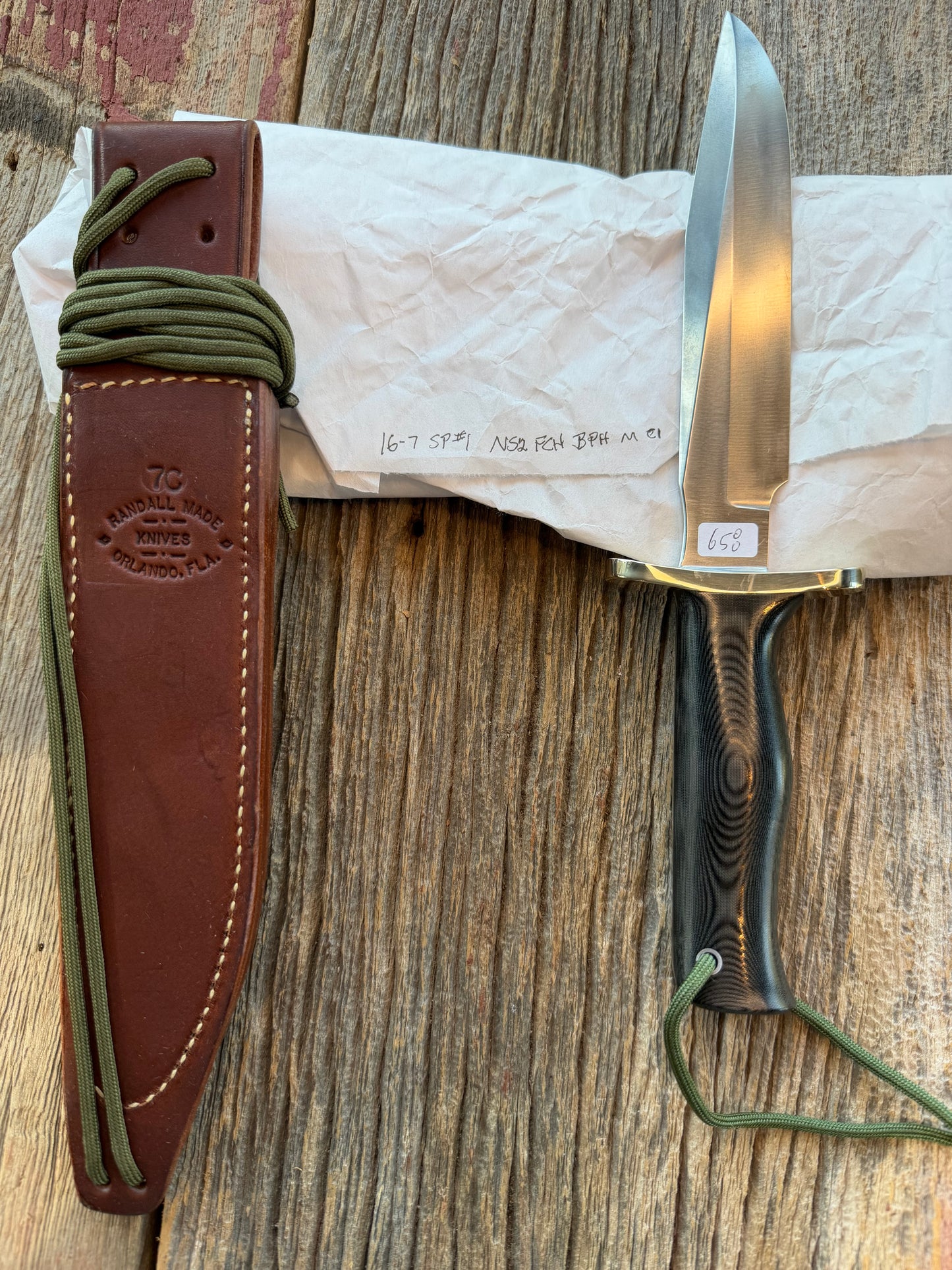 New in Paper Randall Model 16 SP#1 Special fighter with a Black Micarta handle. SS blade, Nickel silver Forward Curved hilt. Lanyard. Brown leather sheath.