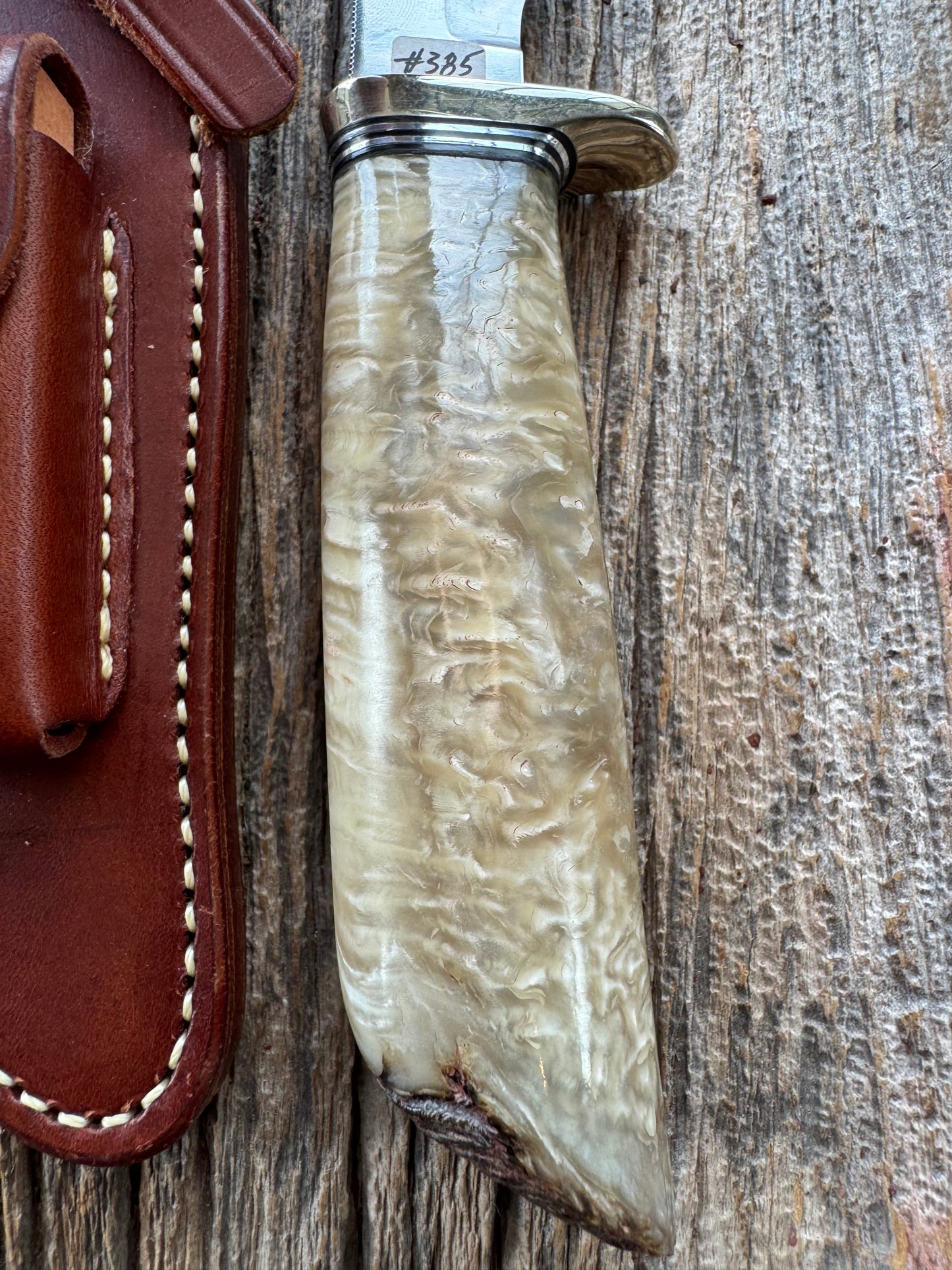 Randall Model 12-6 in Musk Ox. Natural raw end. Nickel Silver Single Hilt and Black and Aluminum spacers, stainless steel blade.