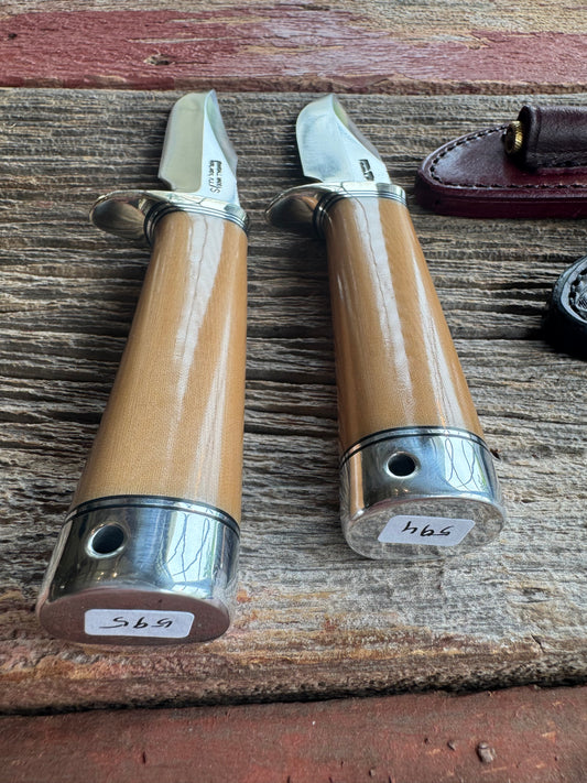 A pair of Randall Stanaback Specials in Bone Linen Micarta. A large and the small Stanaback with a 4 and a 4 1/2” Stainless steel Blade, Nickel Silver Single Hilt with Aluminum & Black Spacers. Nickel silver butt caps and a Lanyard. Special Edition