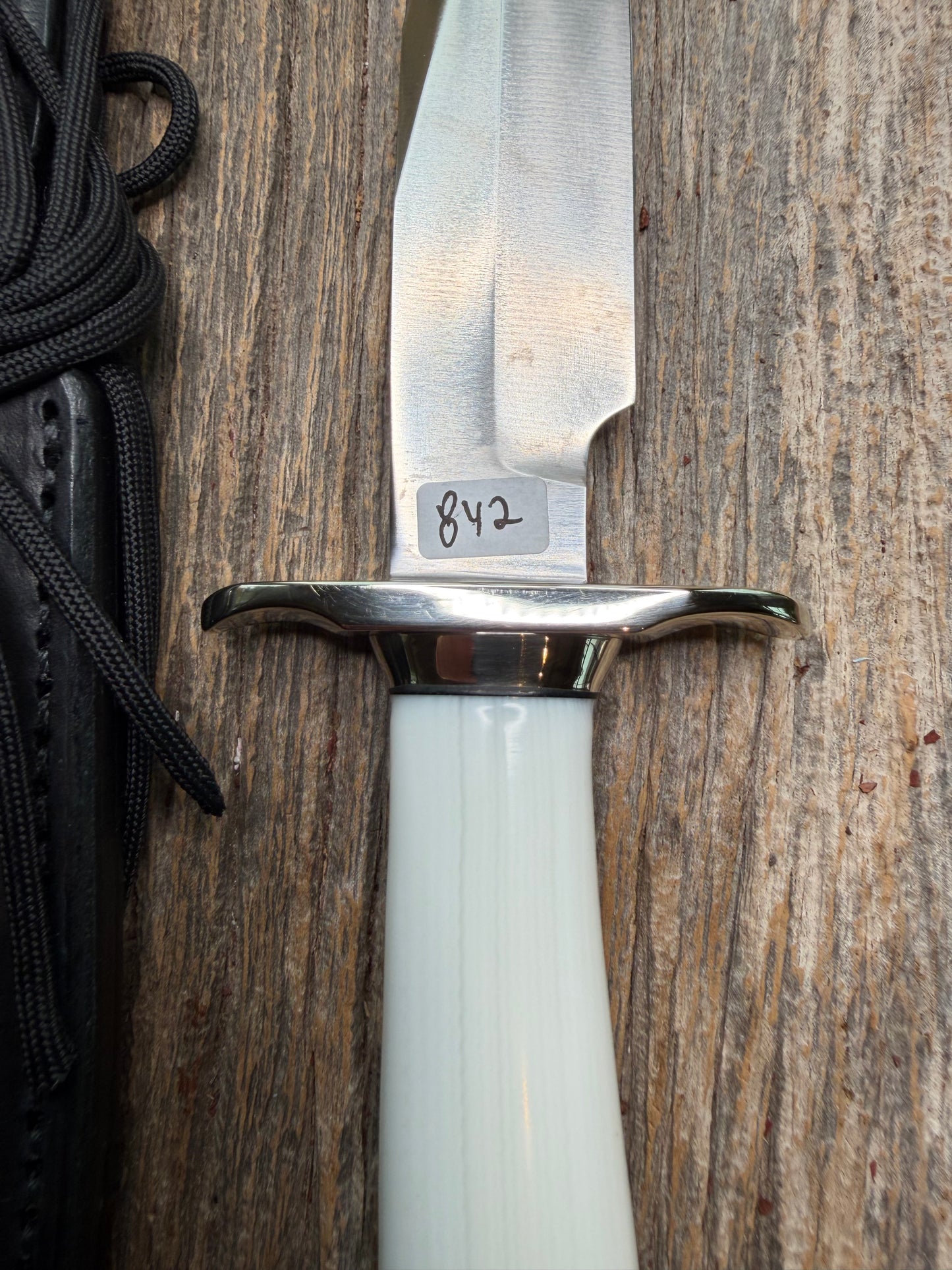 Randall Model 15 with a White Ivorite handle. Stainless steel blade, Nickel silver hilt and collar. Upgraded Black leather sheath. Roundsd Aluminum butt cap.