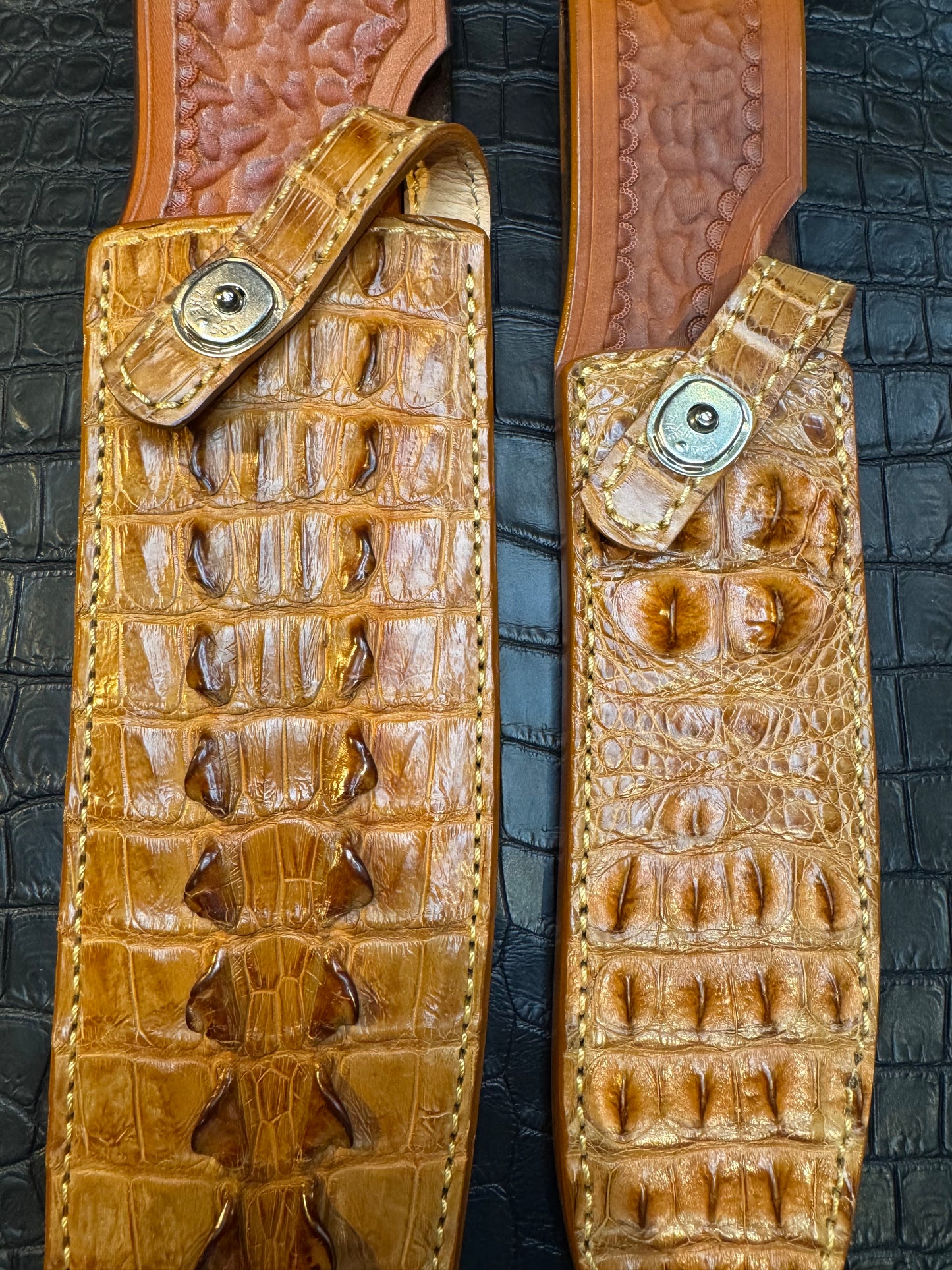 A pair of Randall Model 12-11 Large Sasquatch (Tail) and Randall Model 12-8 Small Sasquatch (Skull) Sheaths in Exotic Tan Hornback Crocodile by Treeman.