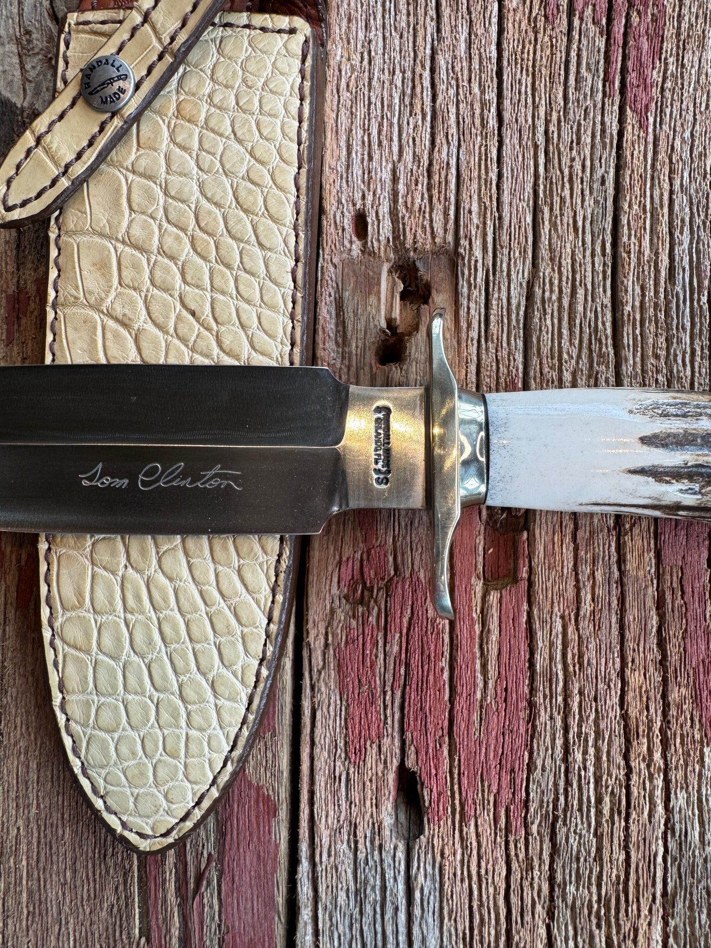 Randall Tom Clinton Dealer Special. Clinton Blade etched Commemorative 1/100 in a nice piece of Stag. Very cool Ostrich Gutcher sheath. Nickel Silver Hilt and Nickel Butt cap. Included in black facsimile Tom Clinton case.