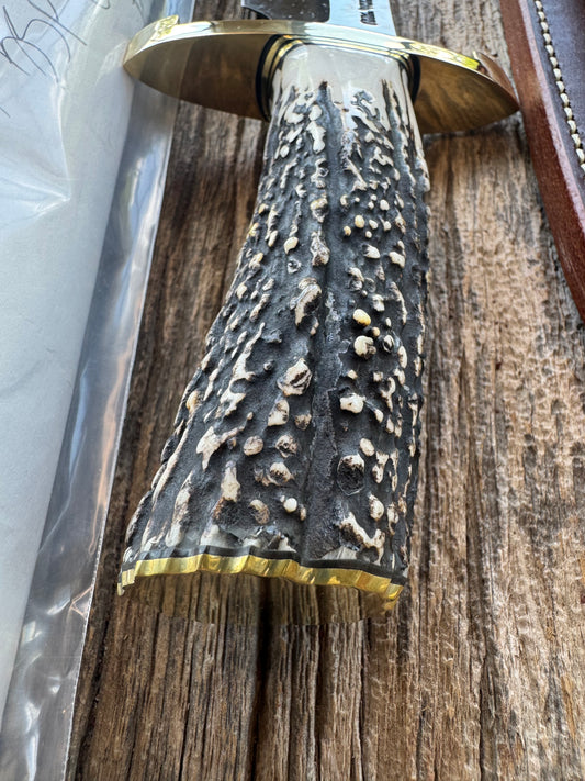 New in paper Randall Model 12-9/14 Grind Bowie with a Huge piece of Popcorn Stag. Brass Lugged Hilt and brass Butt plate.
