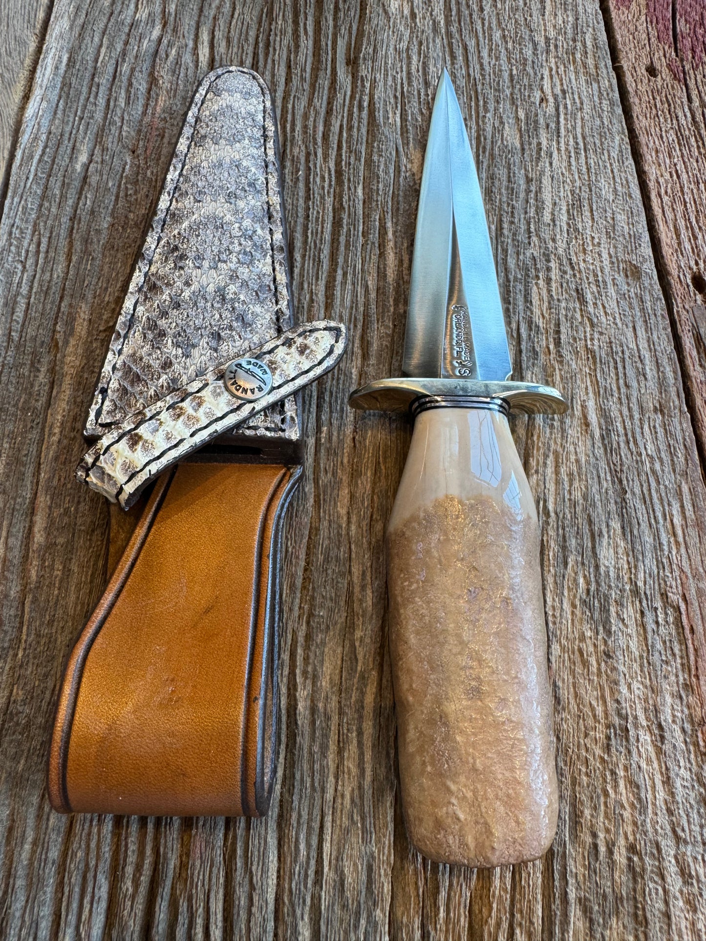 Randall Knife Model 13-6 Small Arkansas Toothpick Artifact. Fossil Walrus in an Ice Ax Handle. Included is a very rare Gutcher Rattlesnake sheath, Stainless Steel.