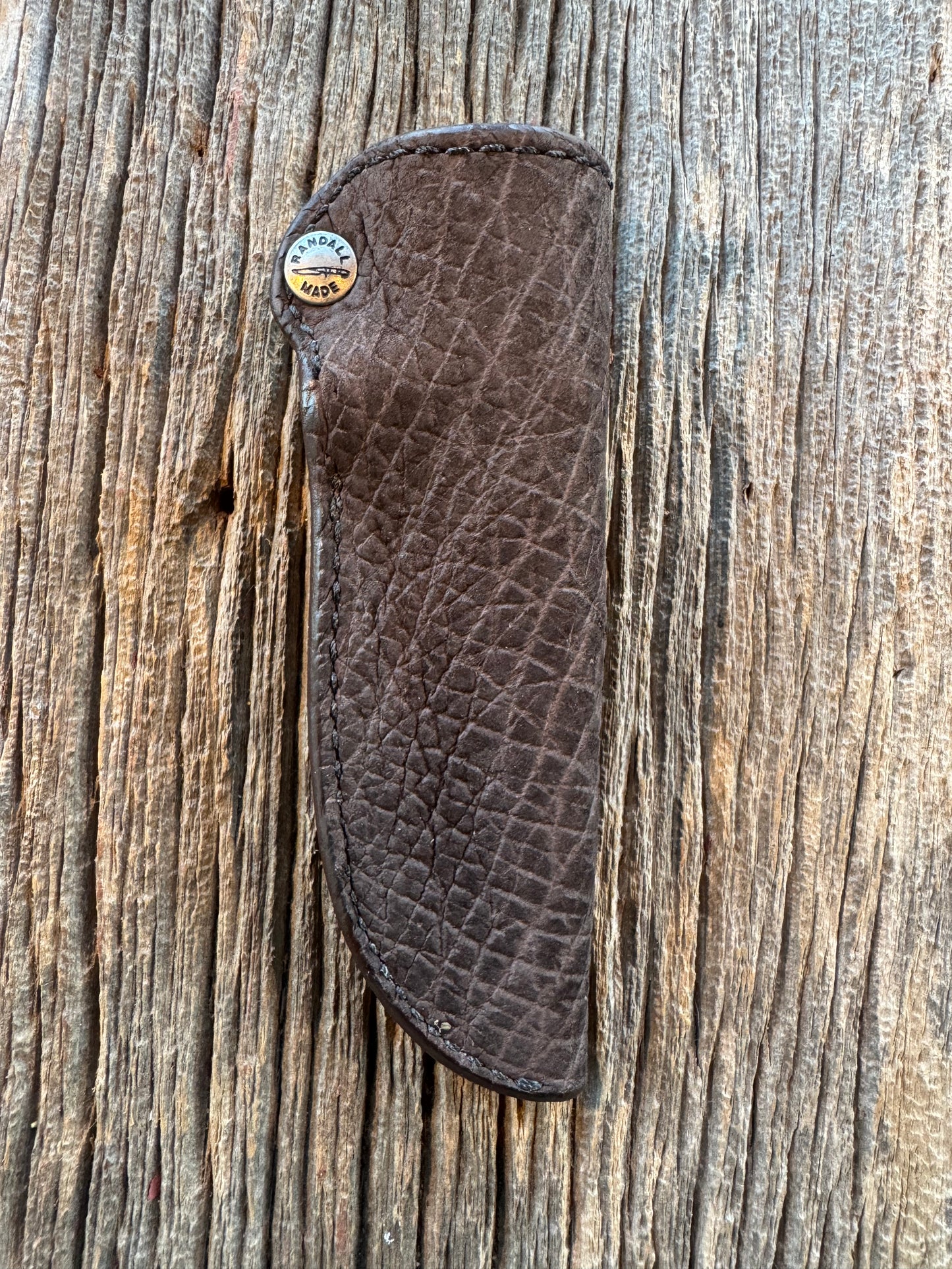 Randall Model 11-4 Sheath in Exotic faded Black Hippo. Snap closure over the hilt , belt loop on the back versus on top. (very rare) Custom Made at Sullivan’s by Gutcher.