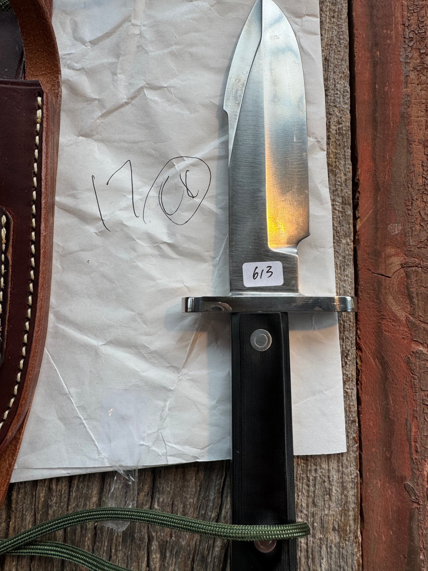 New in Paper Randall Model 17-5.5 Astro knife is a custom, handmade combat knife with a 5.5" stainless steel clip point blade and a brown leather sheath. Full tang design, black handle.