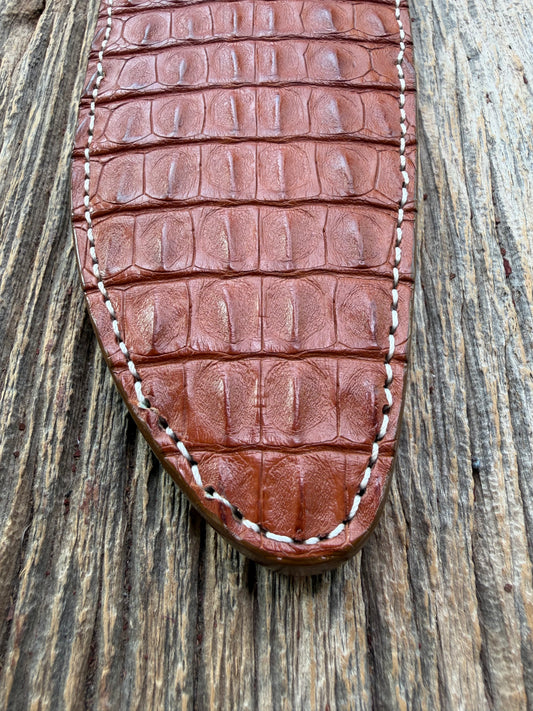 New Randall Model 12-11 Large Sasquatch Sheath in Exotic thick and textured Honey Crocodile skin ( skull portion) on brown leather from Treeman with a silver Canteen snap. Hand tooled belt loop. Killer sheath.