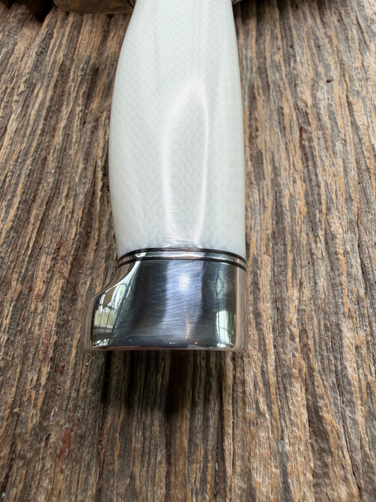 New in Paper Randall Model 19-5 Bushmaster with a White Ivorite handle. Stainless steel blade, Nickel silver hilt. Upgraded Black leather sheath. Crows Beak Aluminum handle.