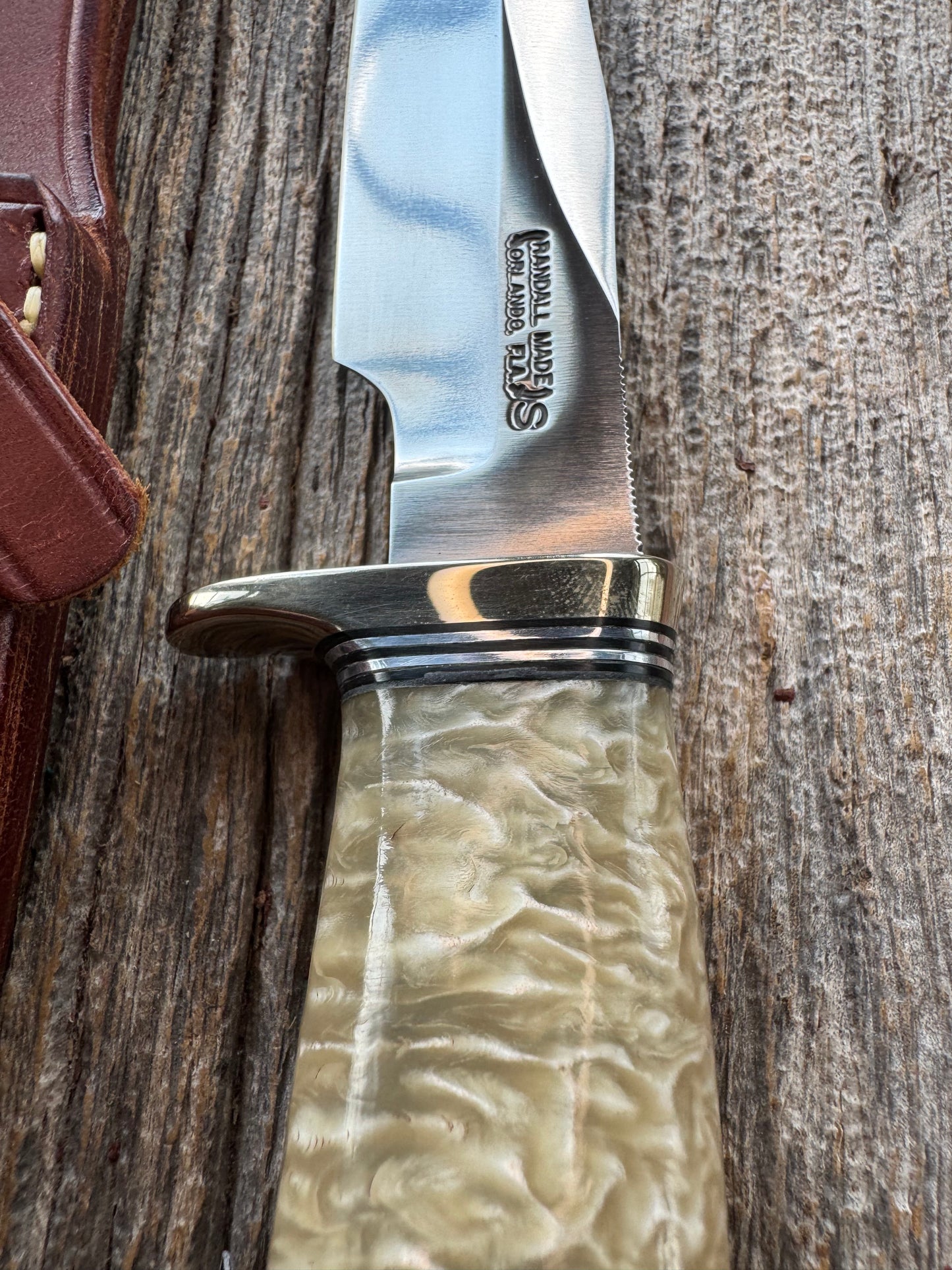 Randall Model 12-6 in Musk Ox. Natural raw end. Nickel Silver Single Hilt and Black and Aluminum spacers, stainless steel blade.