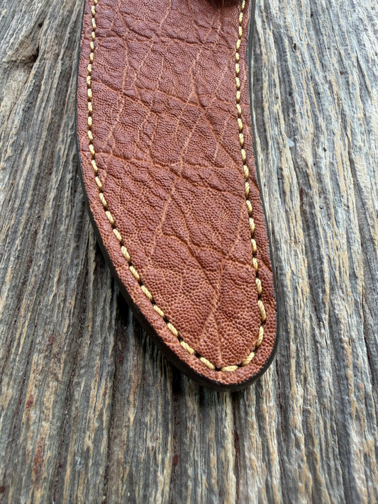 New Randall Model 27 Sheath in Exotic thick and textured Rust colored Elephant hide on brown leather from Treeman with a silver Canteen snap. Hand tooled belt loop. Killer sheath.