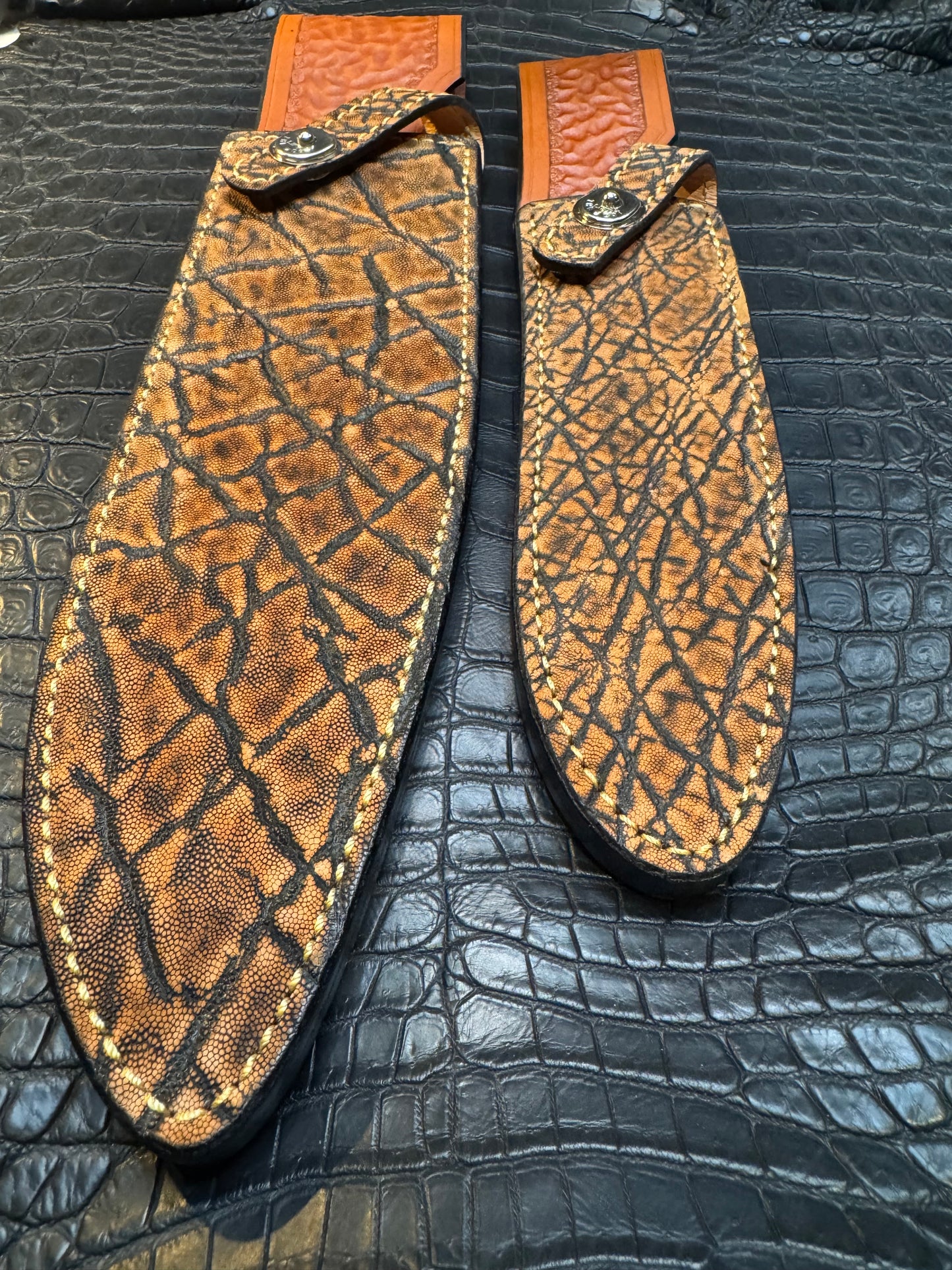 A pair of Randall Model 12-11 Large Sasquatch and Randall Model 12-8 Small Sasquatch Sheaths in Exotic Cognac Elephant by Treeman.