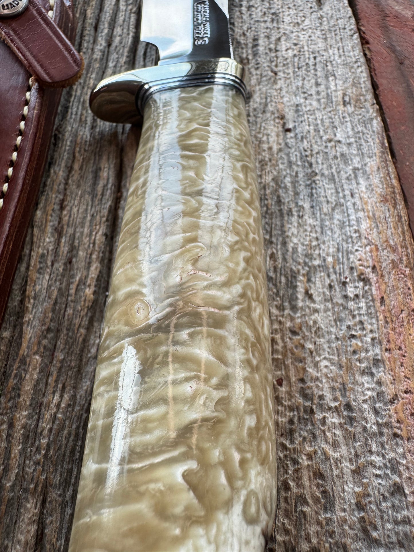 Randall Model 12-6 in Musk Ox. Natural raw end. Nickel Silver Single Hilt and Black and Aluminum spacers, stainless steel blade.