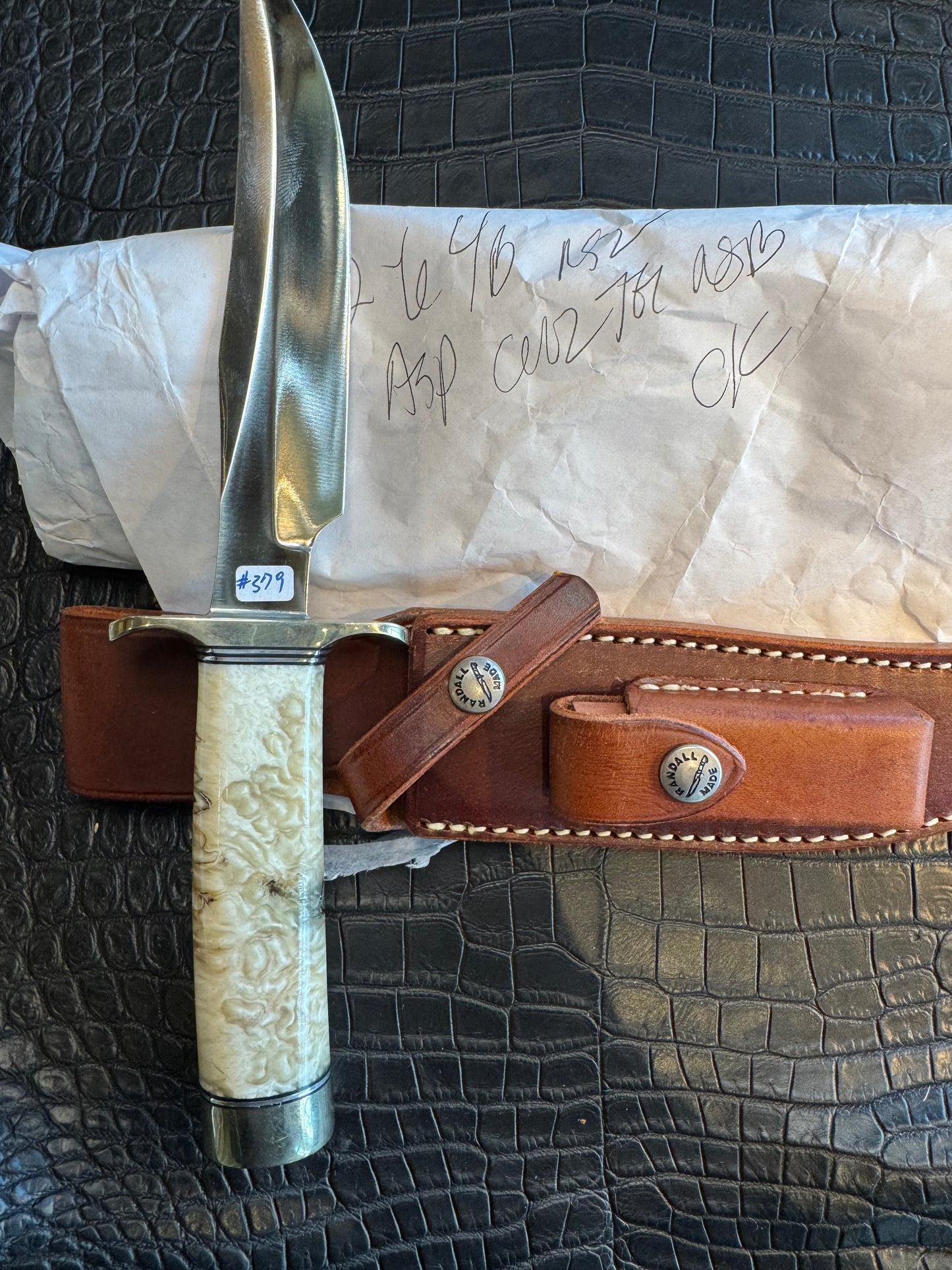In Paper Randall Model 12-6 in Musk Ox. Lead Bullet Fragment embedded in the Musk ox. Nickel Silver Hilt and butt cap.