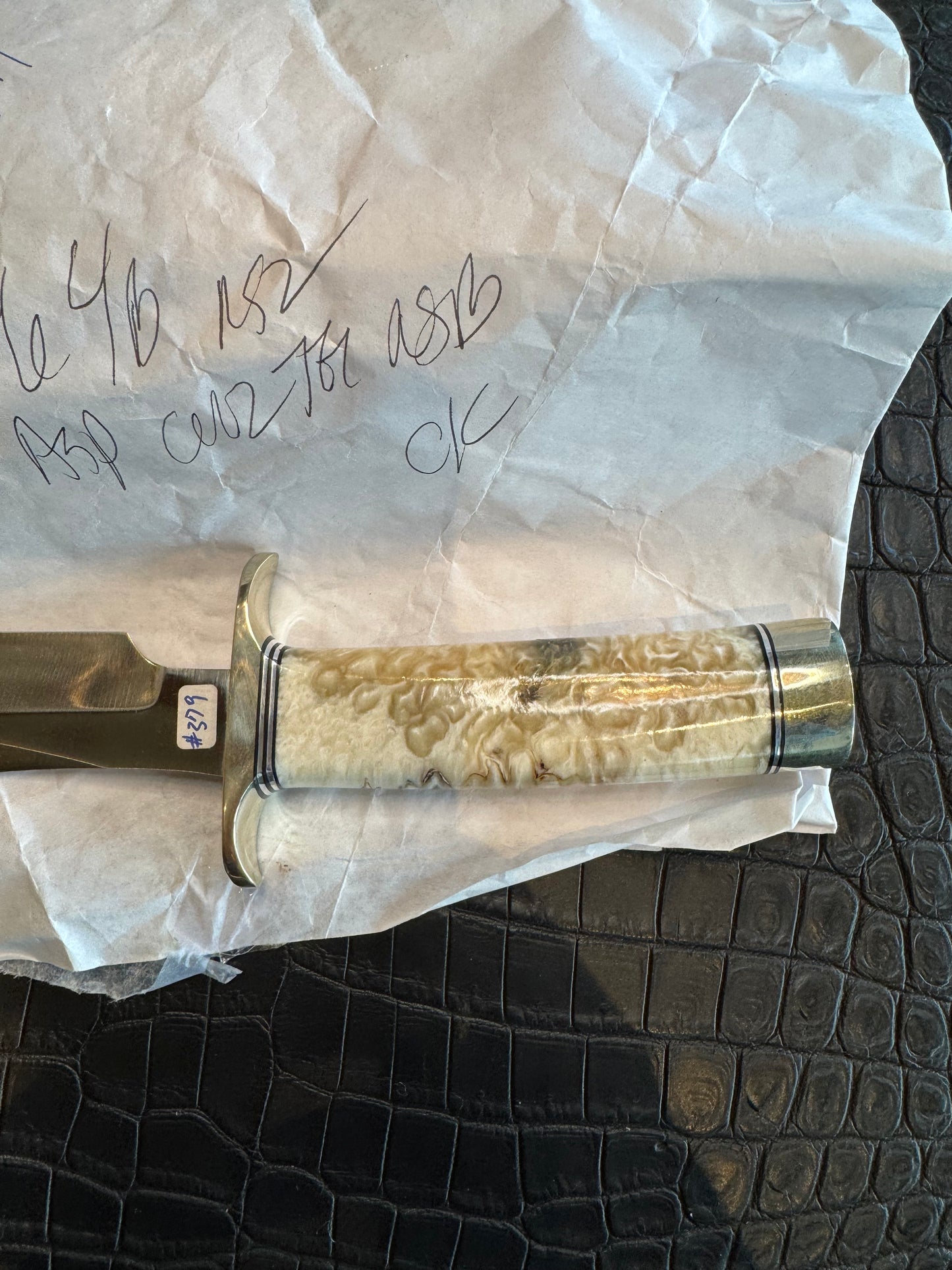 In Paper Randall Model 12-6 in Musk Ox. Lead Bullet Fragment embedded in the Musk ox. Nickel Silver Hilt and butt cap.