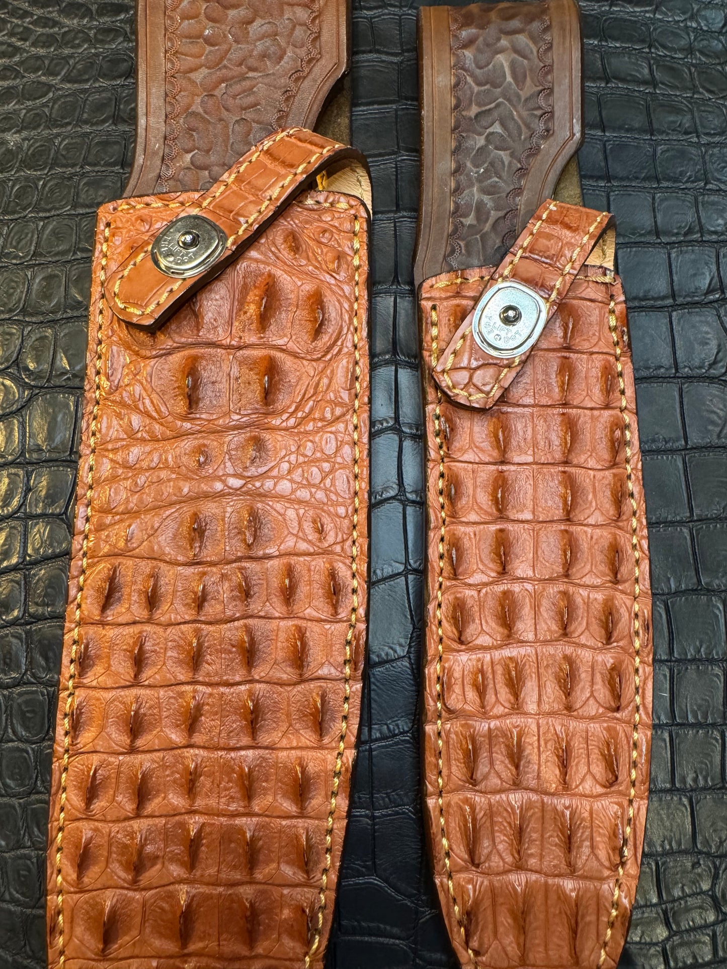 A pair of Randall Model 12-11 Large Sasquatch (Skull) and Randall Model 12-8 Small Sasquatch ( middle back) Sheaths in Exotic Tan Hornback Crocodile by Treeman.