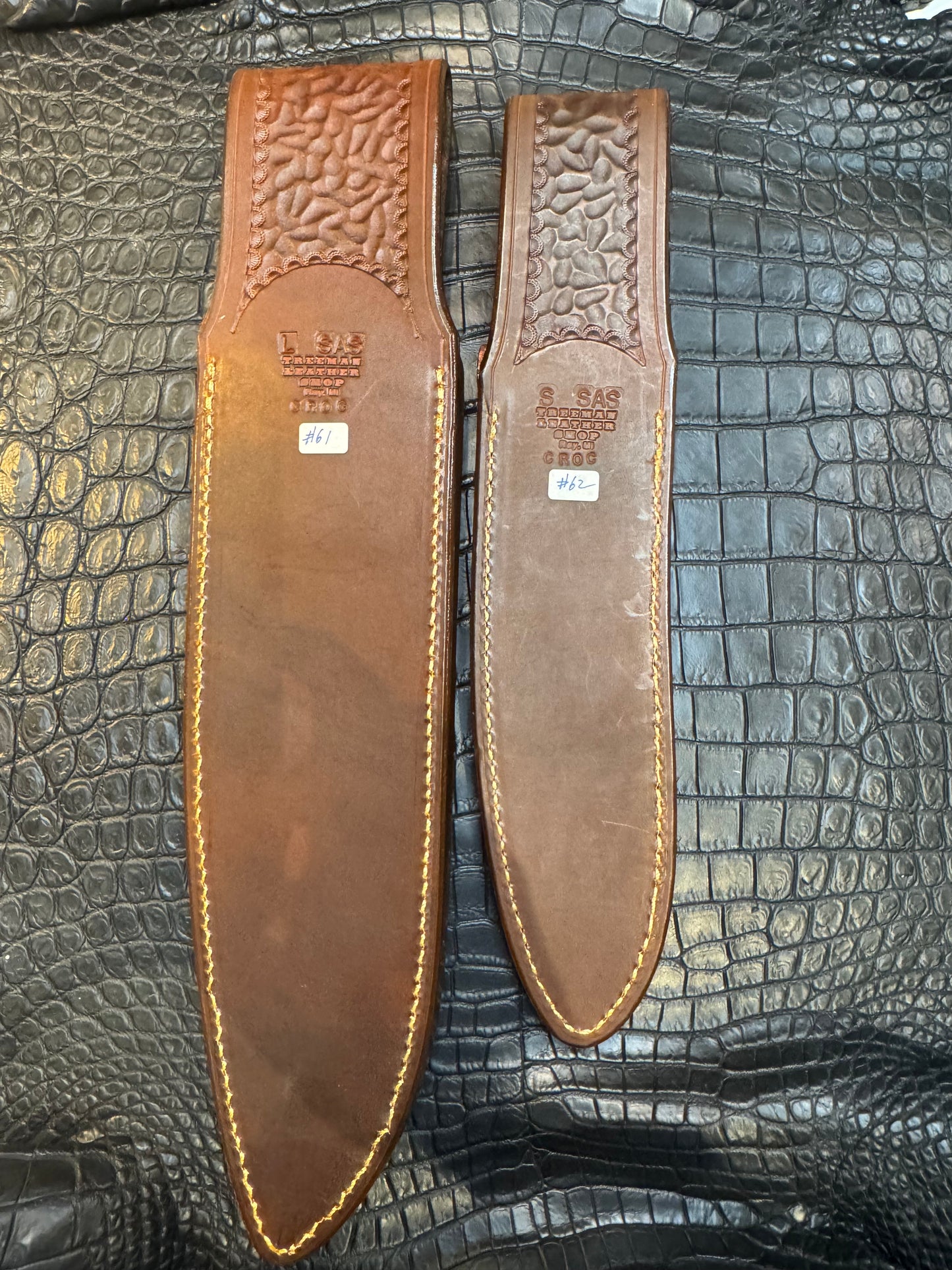 A pair of Randall Model 12-11 Large Sasquatch (Skull) and Randall Model 12-8 Small Sasquatch ( middle back) Sheaths in Exotic Tan Hornback Crocodile by Treeman.