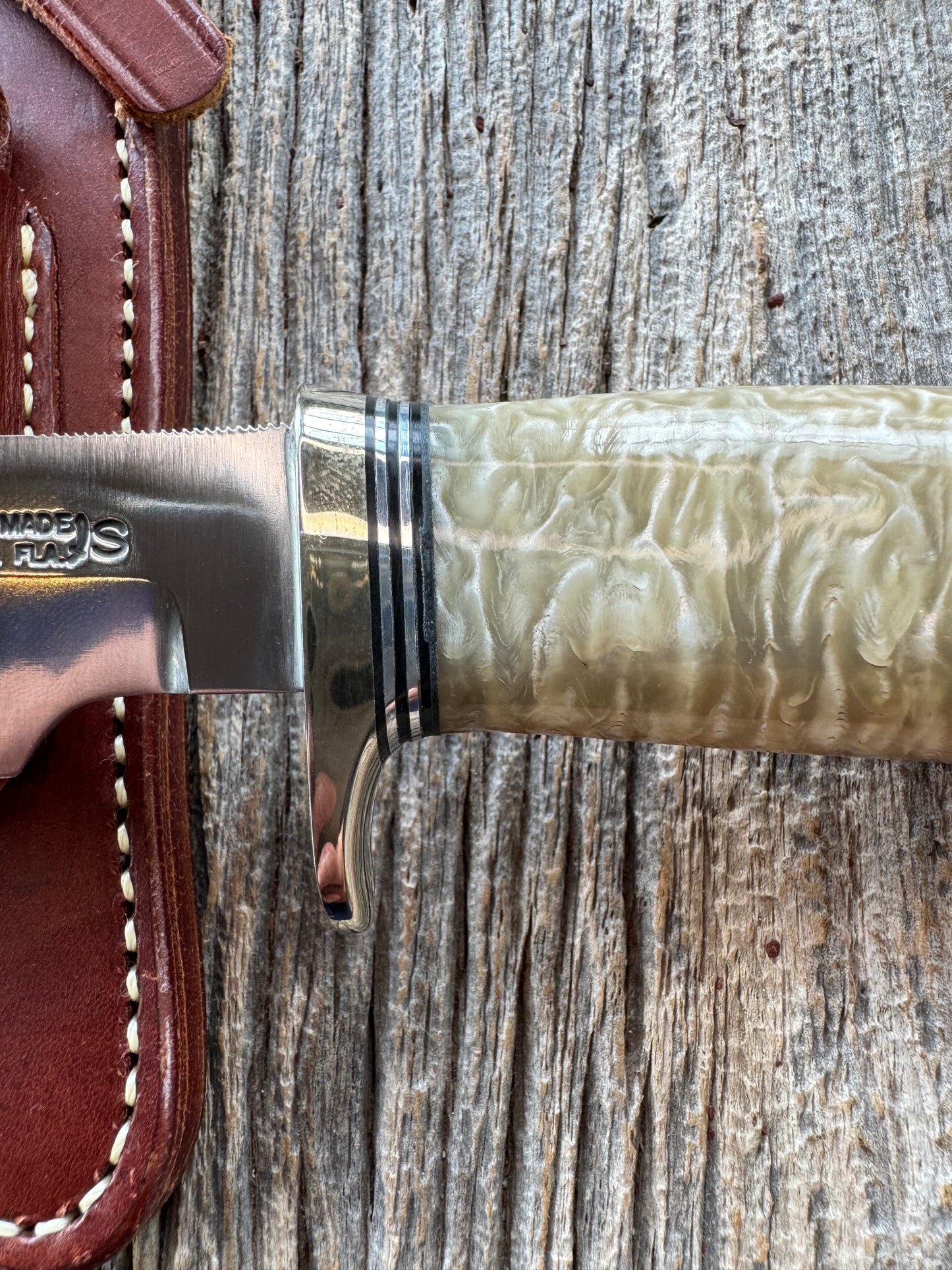 Randall Model 12-6 in Musk Ox. Natural raw end. Nickel Silver Single Hilt and Black and Aluminum spacers, stainless steel blade.
