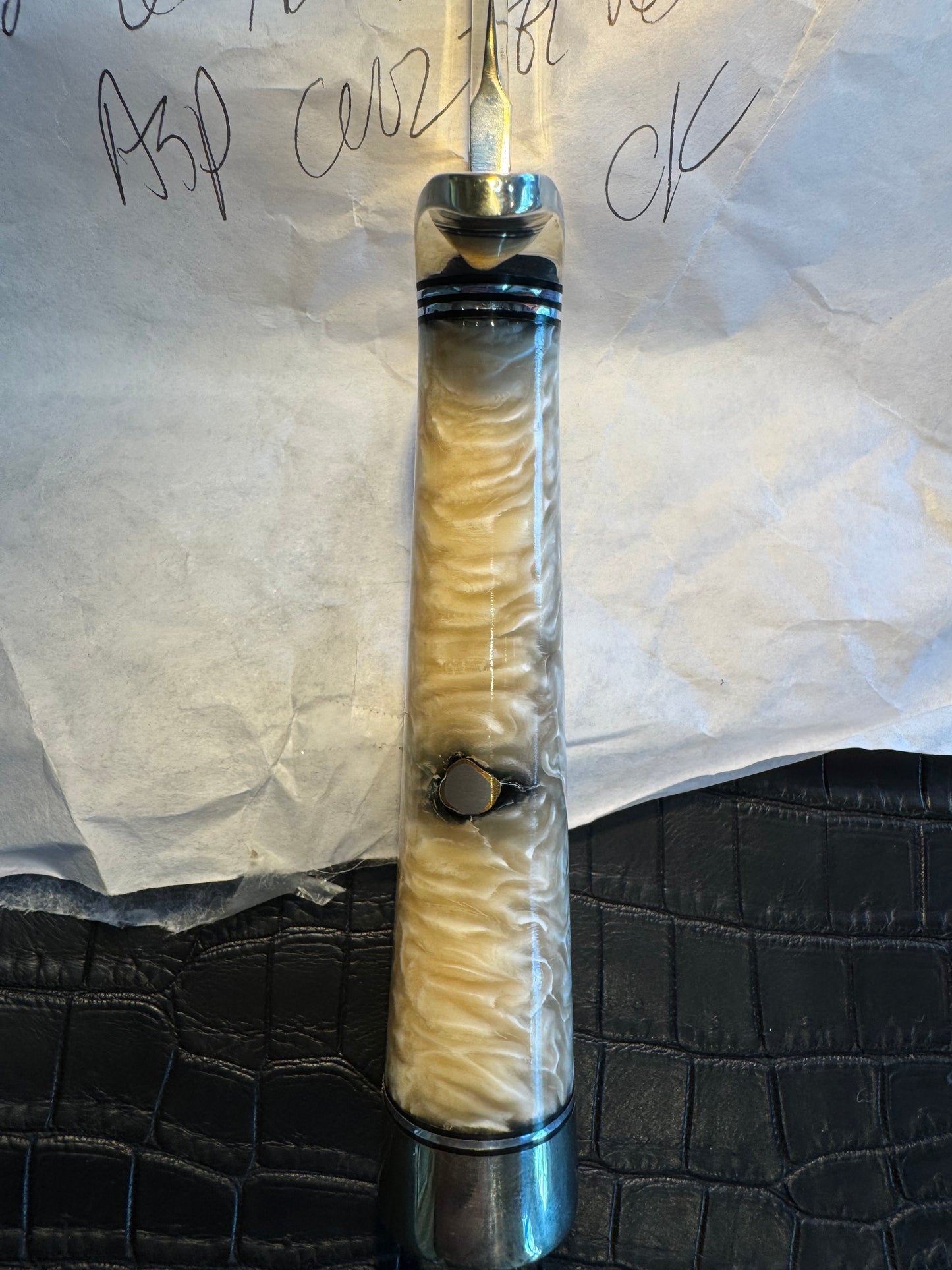 In Paper Randall Model 12-6 in Musk Ox. Lead Bullet Fragment embedded in the Musk ox. Nickel Silver Hilt and butt cap.