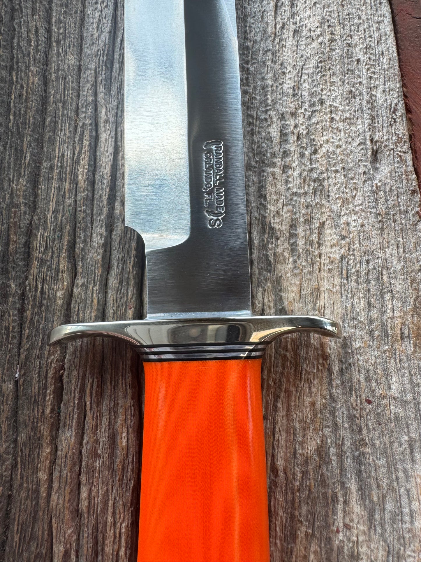 New in paper Randall Model 14 CDT with a nice piece of customer supplied Orange G10. Stainless Steel, Nickel Silver Hilt and Butt cap.