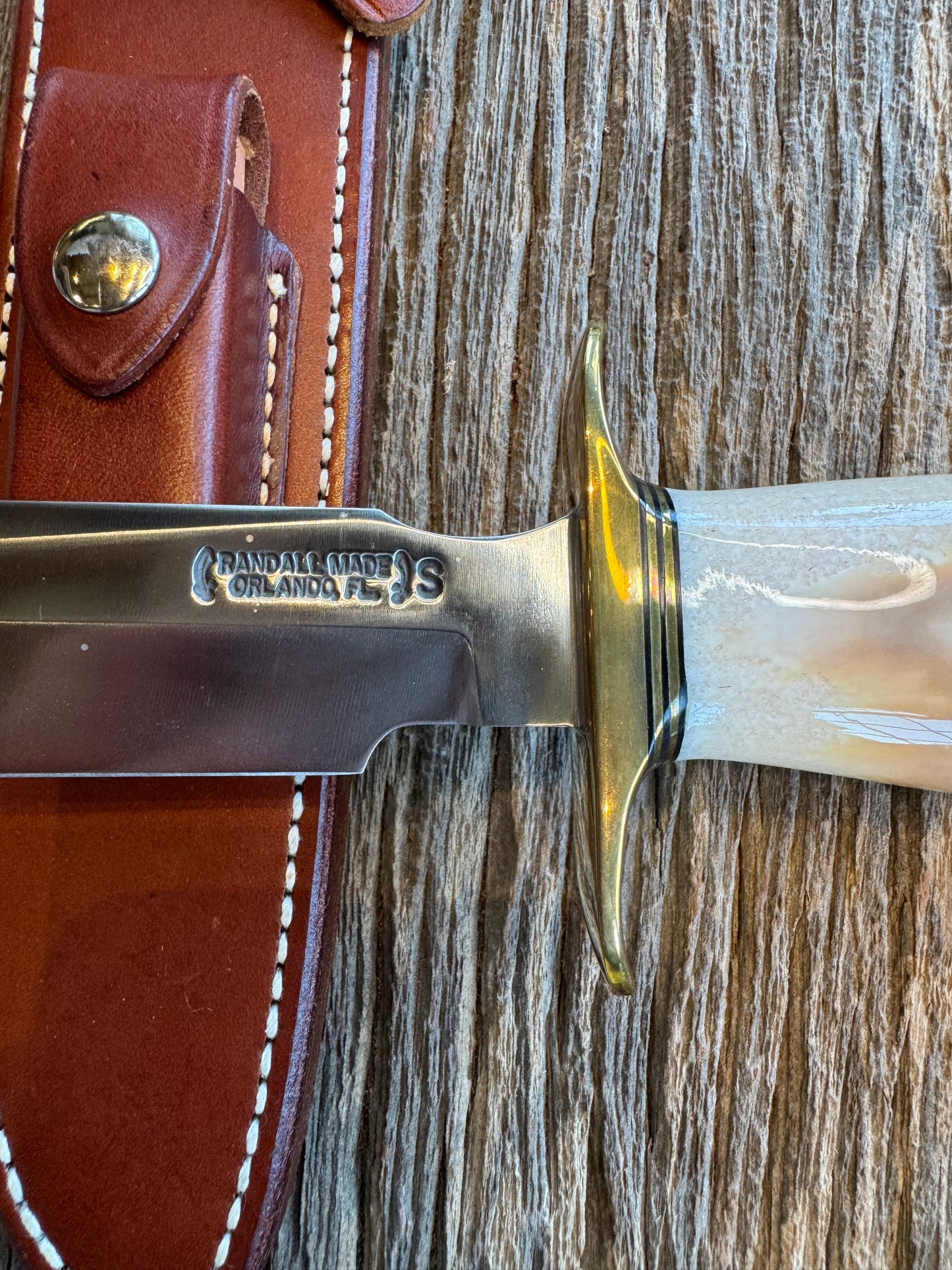 Randall Knife Model 1-8 Creamy Fossil Walrus Handle. From the Jim Gates Collection via Rick Bowles. Stainless Steel, Brass Hilt and butt plate.