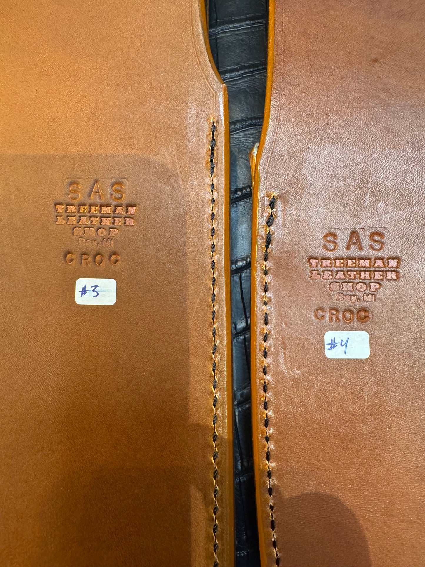 A pair of Randall Model 12-11 Large Sasquatch and Randall Model 12-8 Small Sasquatch Sheaths in Exotic Ivory Crocodile by Treeman.