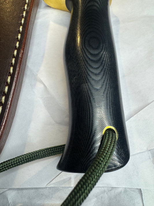 New in Paper Randall Model 28 Woodsman in Black Micarta. SS blade, brass single hilt. Lanyard. Brown leather sheath.