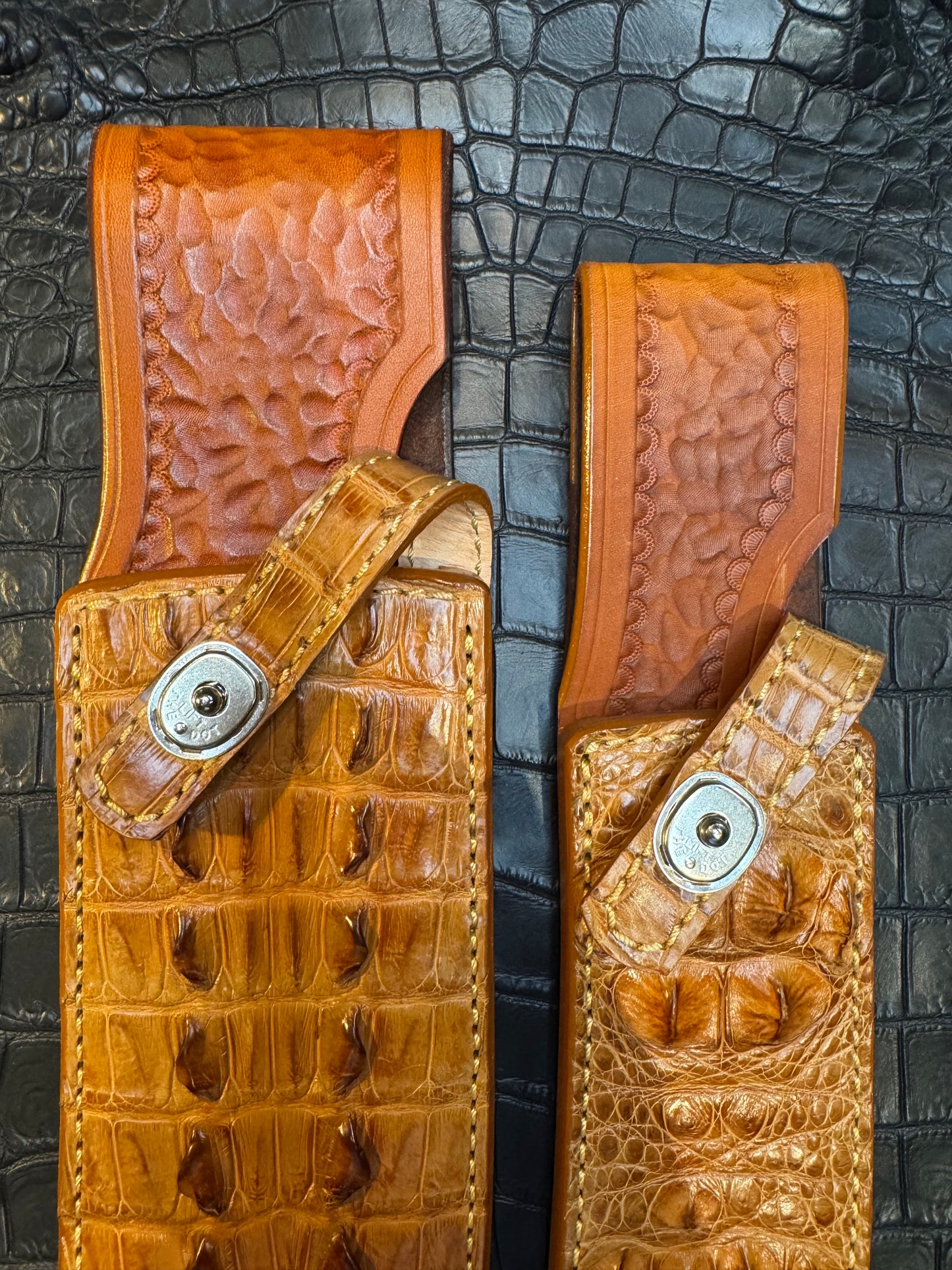 A pair of Randall Model 12-11 Large Sasquatch (Tail) and Randall Model 12-8 Small Sasquatch (Skull) Sheaths in Exotic Tan Hornback Crocodile by Treeman.