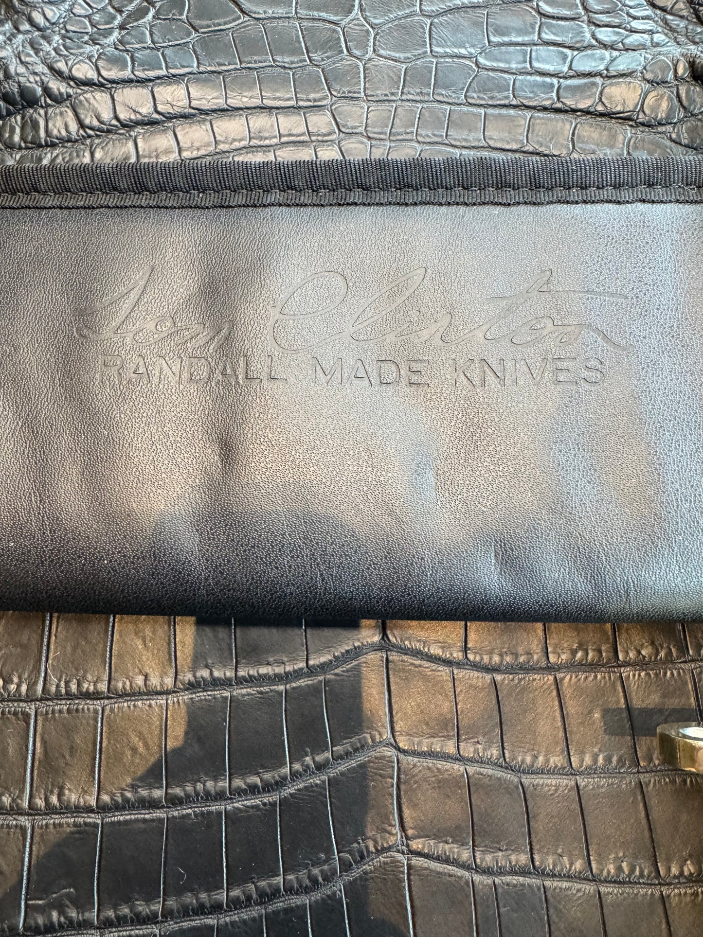 Randall Tom Clinton Dealer Special. Clinton Blade etched Commemorative 1/100 in a nice piece of finger grooved Ivorite. Very cool Black Crocodile skull Gutcher sheath. Nickel Silver Hilt. Included in black facsimile Tom Clinton case.
