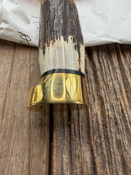 New in paper fresh from the Shop. Randall Knife Model 14-7.5 Big. Nice piece of Stag, Gorgeous Brass Lugged hilt and brass crows beak butt cap. Single black spacer. Stainless steel.