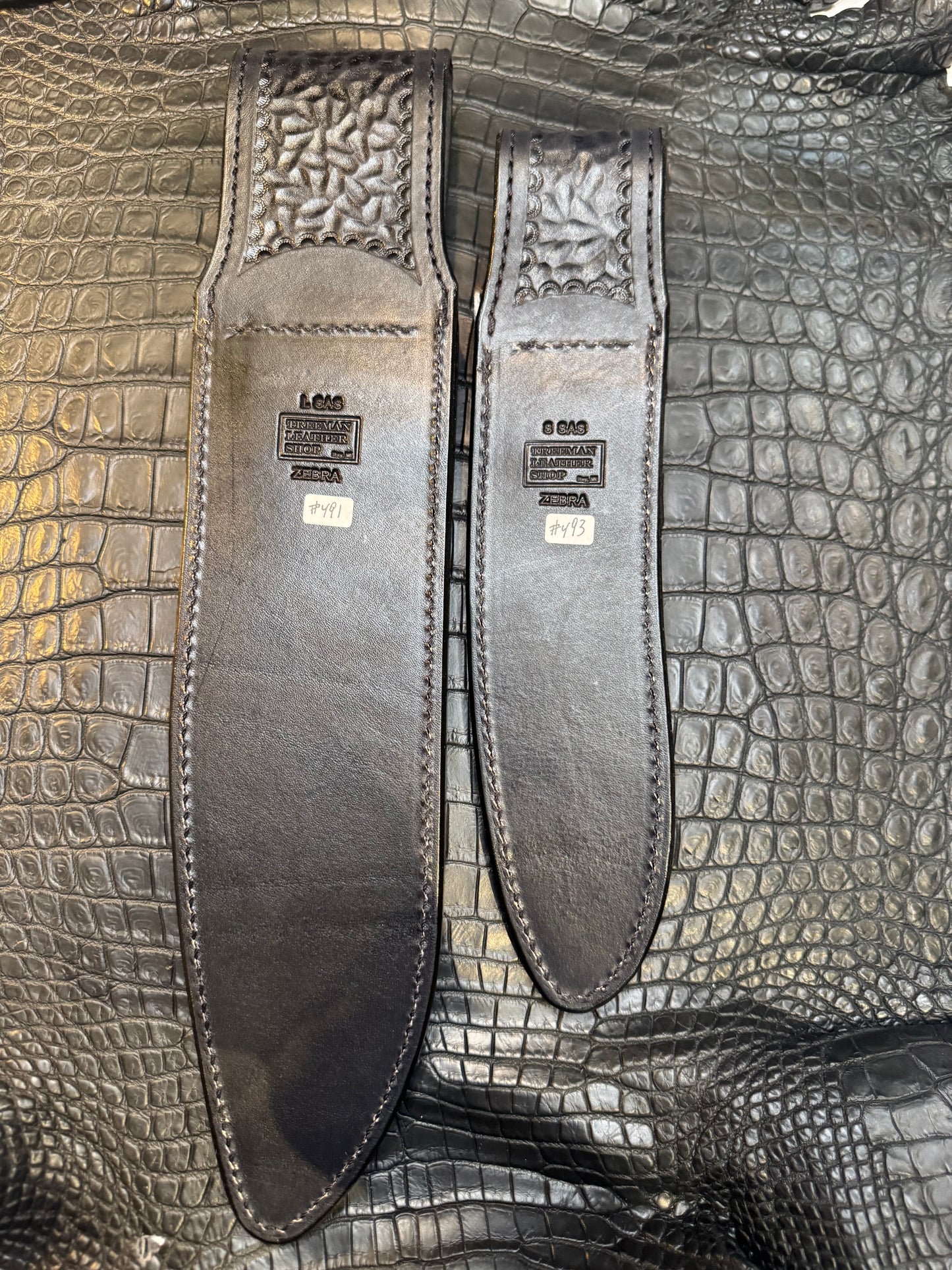 A pair of Randall Model 12-11 Large Sasquatch and Randall Model 12-8 Small Sasquatch Sheaths in Exotic Zebra by Treeman.