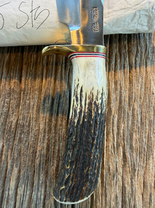 New in Paper Randall Model 19-5 Bushmaster with a Stag handle. Carbon blade, Nickel silver single hilt. Brown leather sheath.