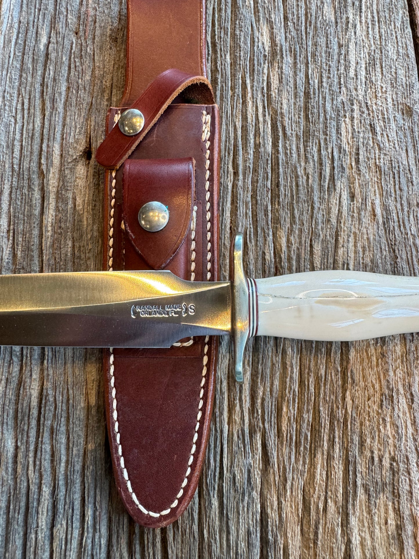 Randall Knife Model 2-7 Creamy Fossil Walrus Handle. Older model with beautiful green and white spacers. Handle is cracked ( see pics) Stainless Steel, Nickel silver Hilt and aluminum butt cap with lanyard.