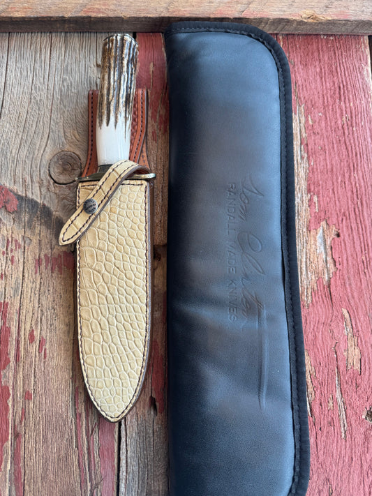 Randall Tom Clinton Dealer Special. Clinton Blade etched Commemorative 1/100 in a nice piece of Stag. Very cool Ostrich Gutcher sheath. Nickel Silver Hilt and Nickel Butt cap. Included in black facsimile Tom Clinton case.