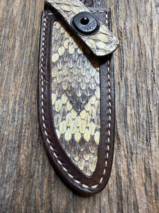 Randall Model 23 sheath with an Eastern Diamondback RattleSnake skin from Treeman Sheaths. Hand tooled belt loop, canteen snap. One the hardest skins to source.