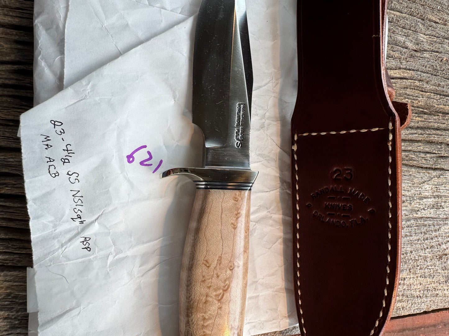 New in Paper Randall Model 23 Game Master Stainless steel blade, Nickel silver hilt and aluminum butt cap. Brown leather sheath. Maple wood handle.