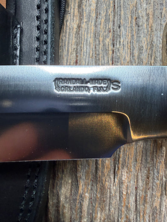 Randall Model 14-7.5 with a White Ivorite handle. Stainless steel blade, Nickel silver hilt and collar. Upgraded Black leather sheath. Roundsd Aluminum butt cap.