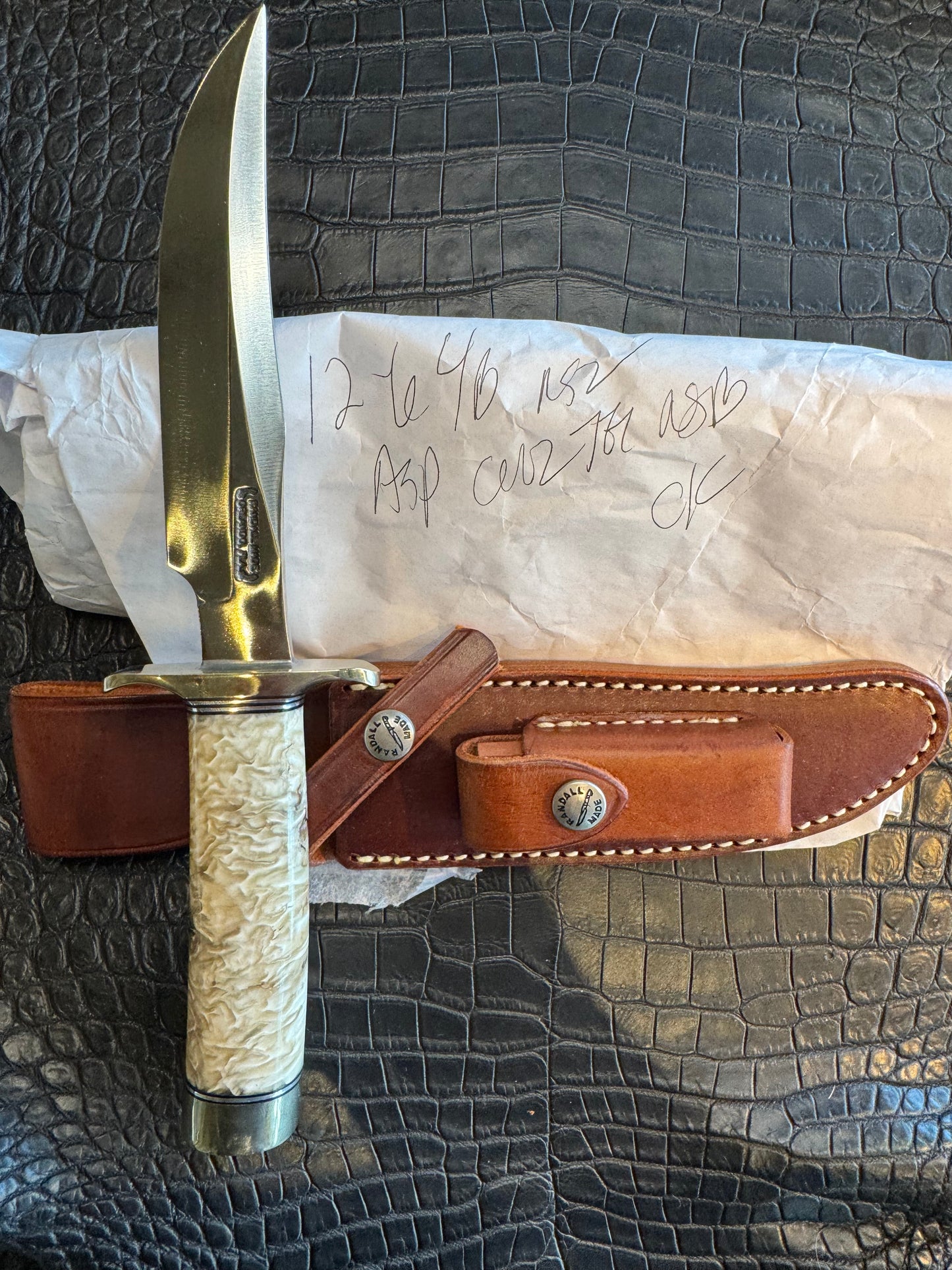 In Paper Randall Model 12-6 in Musk Ox. Lead Bullet Fragment embedded in the Musk ox. Nickel Silver Hilt and butt cap.