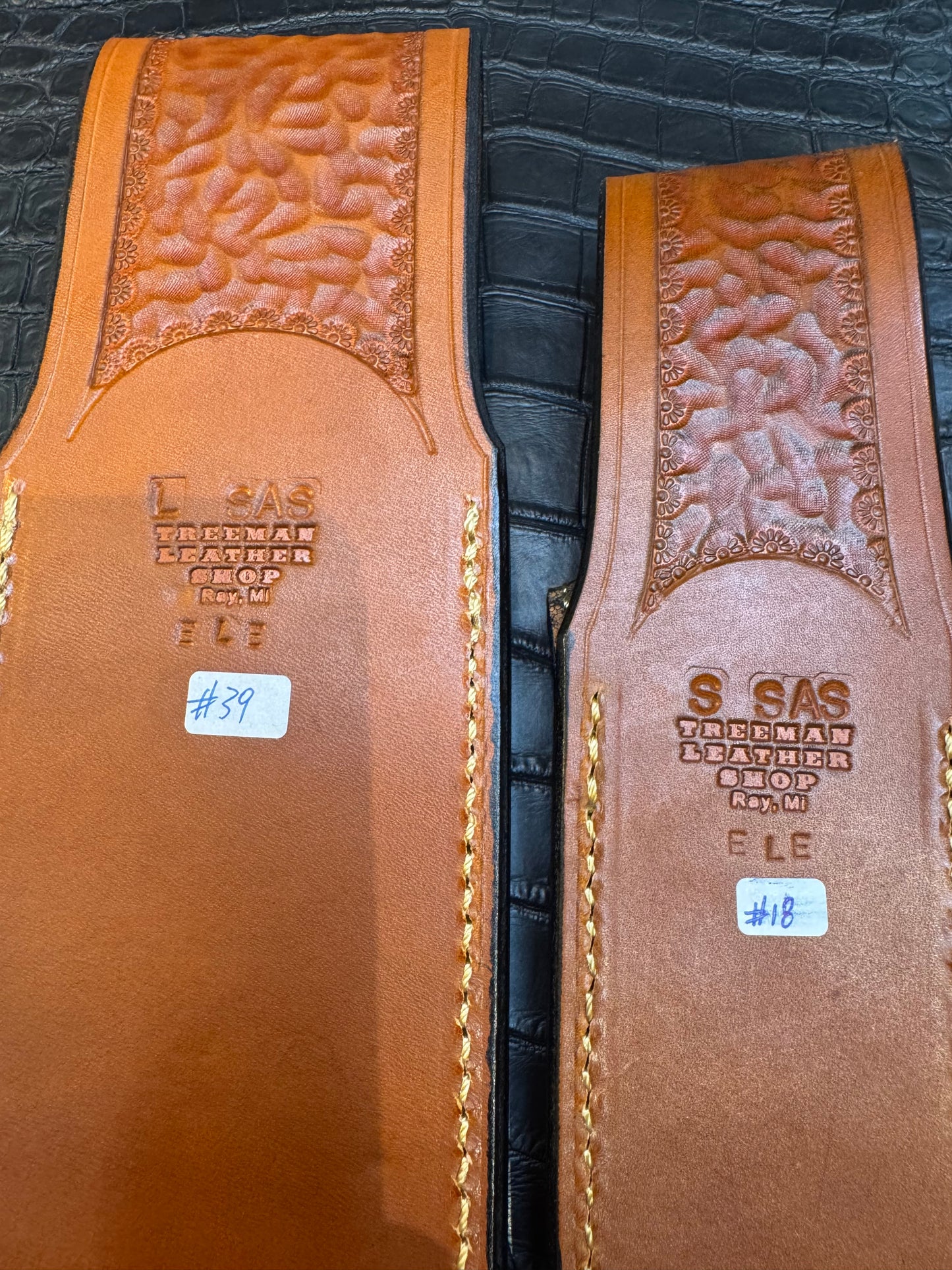 A pair of Randall Model 12-11 Large Sasquatch and Randall Model 12-8 Small Sasquatch Sheaths in Exotic Cognac Elephant by Treeman.