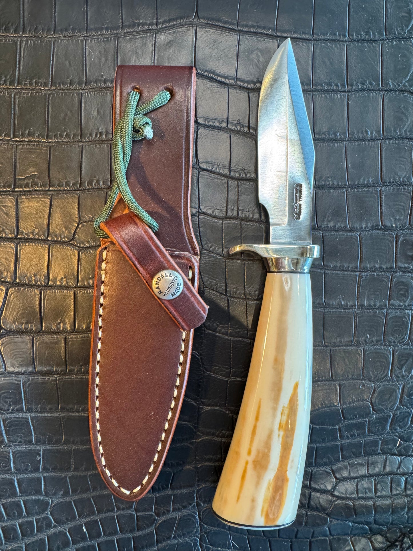 News in Paper Randall Model 8-4 in a gorgeous piece of Cream and Blue Fossil Walrus Ivory. Nickel Silver single hilt with a nickel Collar and butt cap.