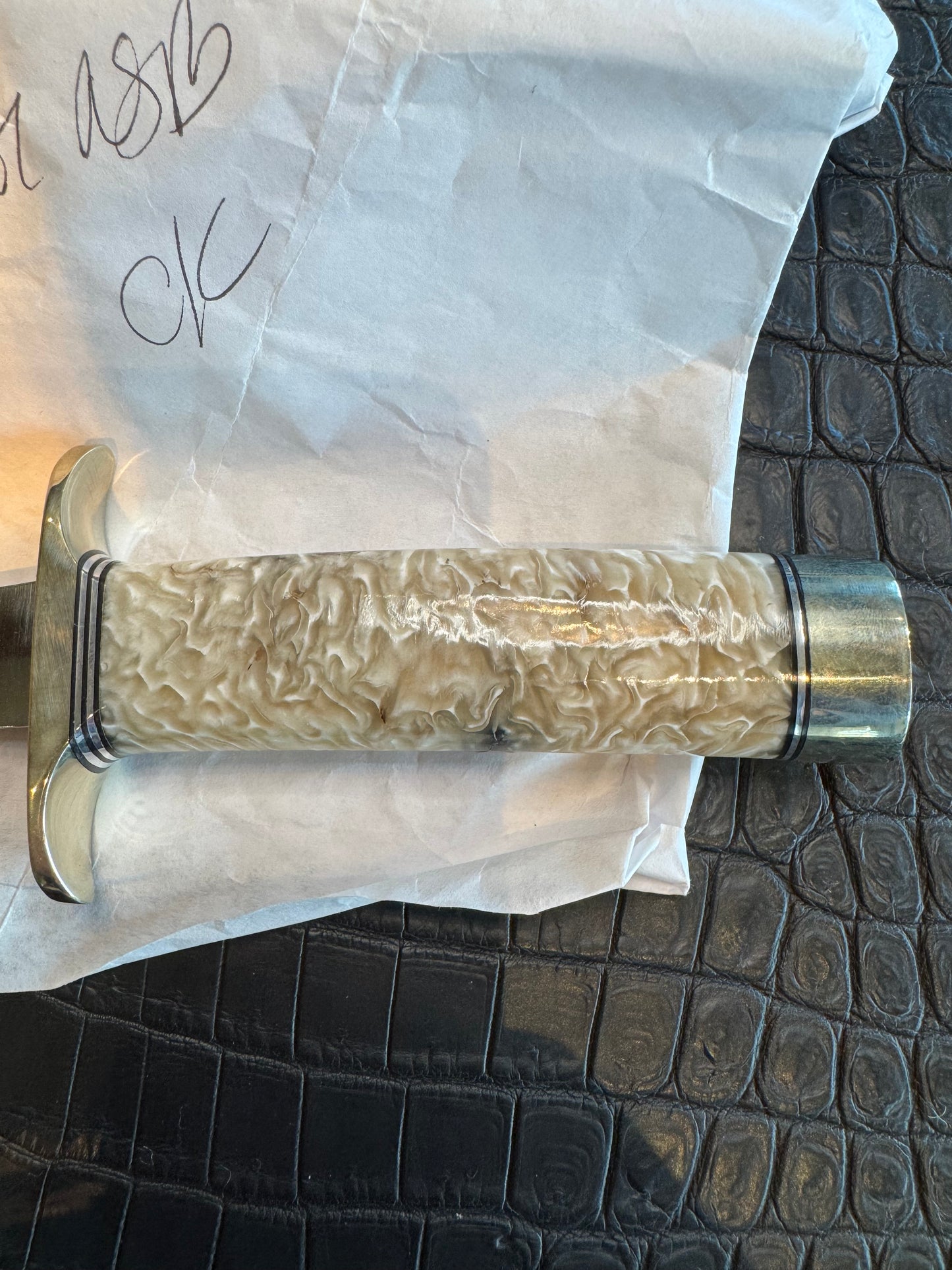 In Paper Randall Model 12-6 in Musk Ox. Lead Bullet Fragment embedded in the Musk ox. Nickel Silver Hilt and butt cap.