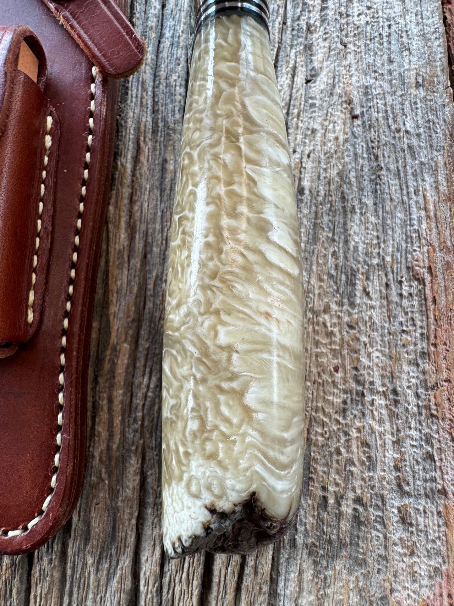 Randall Model 12-6 in Musk Ox. Natural raw end. Nickel Silver Single Hilt and Black and Aluminum spacers, stainless steel blade.