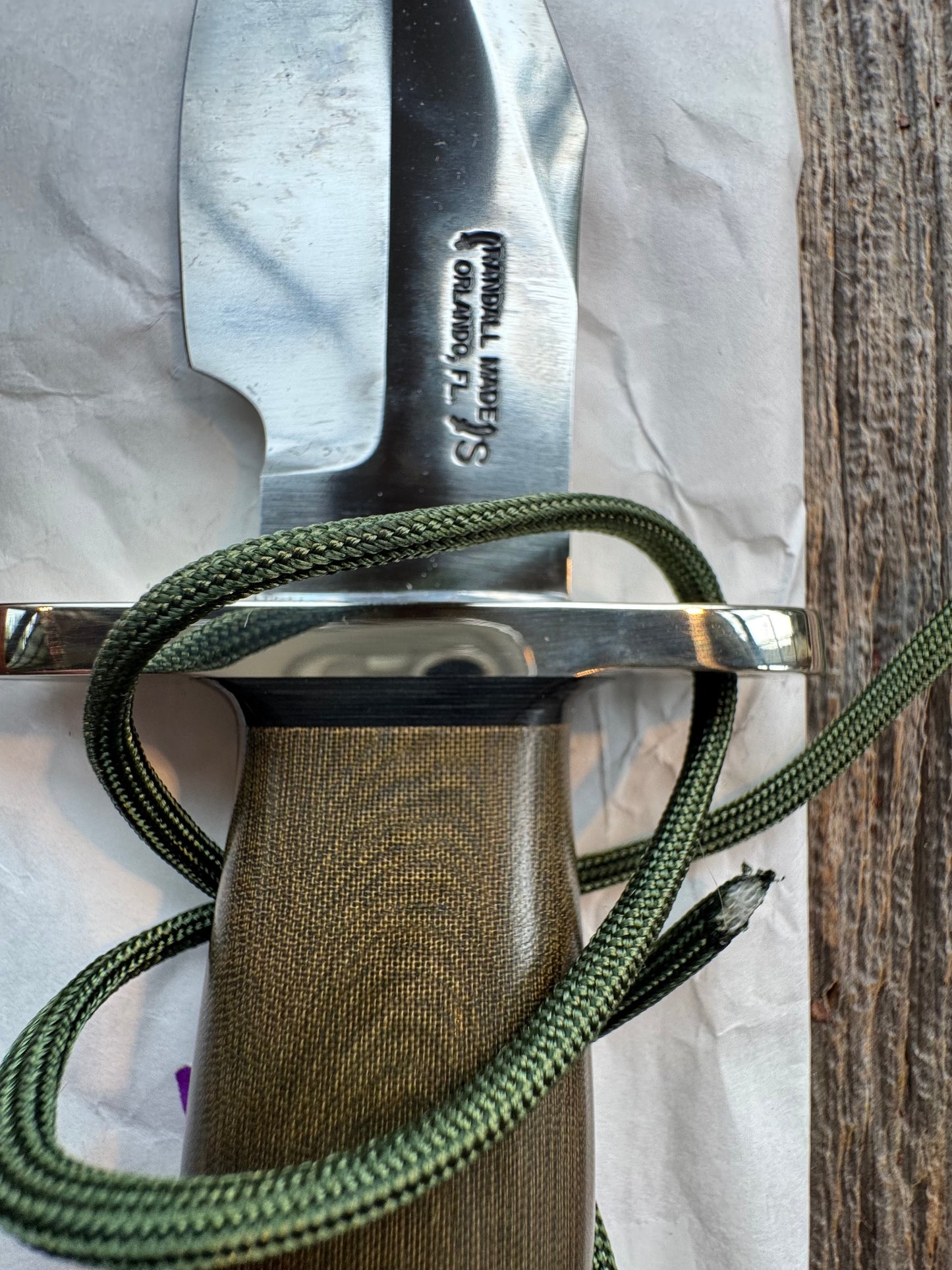 New in Paper Randall Model 19-5 Bushmaster with an Green Micarta handle. SS blade, Nickel silver single hilt. Lanyard. Brown leather sheath.