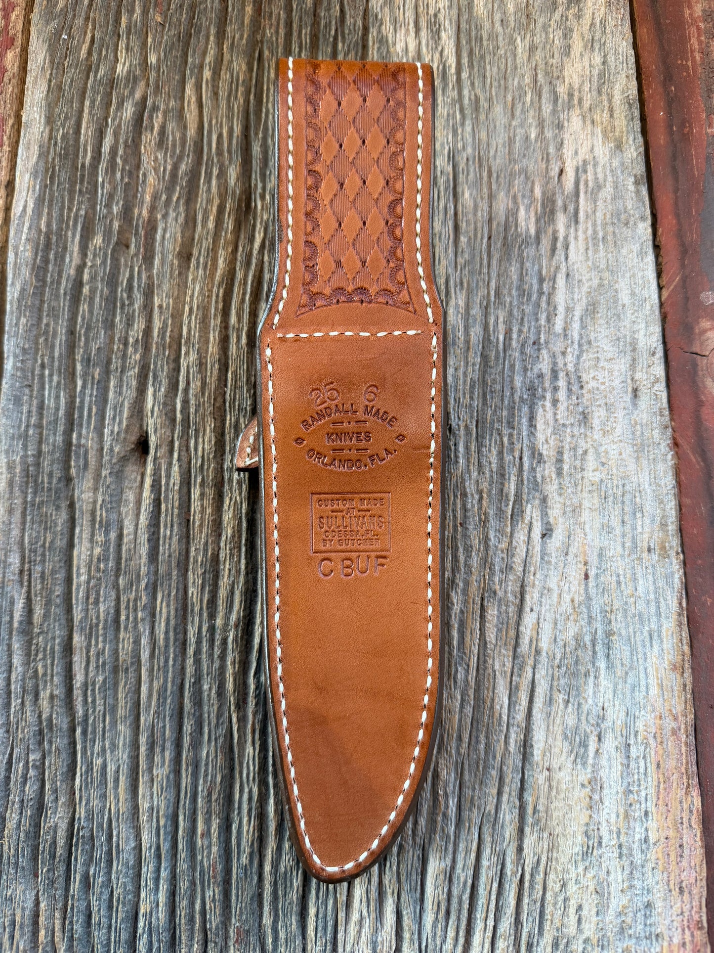 New Randall Model 25-6 Sheath in Exotic Brown Cape Buffalo with full leather hand tooled belt loop. Randall snap and stamp on the back. Custom Made at Sullivan’s by Gutcher