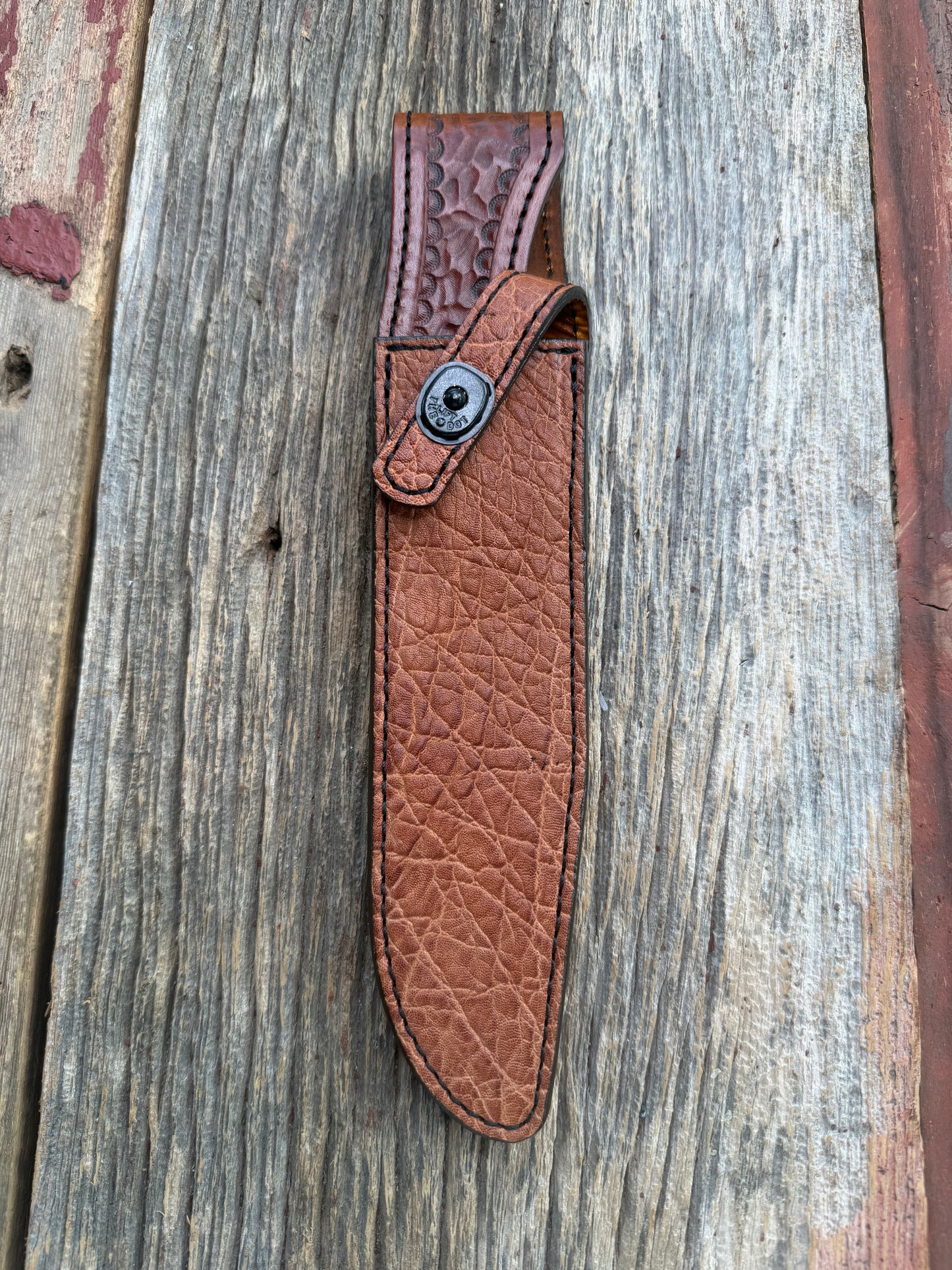 New Randall Model 1-8 Sheath in Exotic thick and textured Rust colored Elephant hide on brown leather from Treeman with a black Canteen snap. Hand tooled belt loop. Killer sheath.